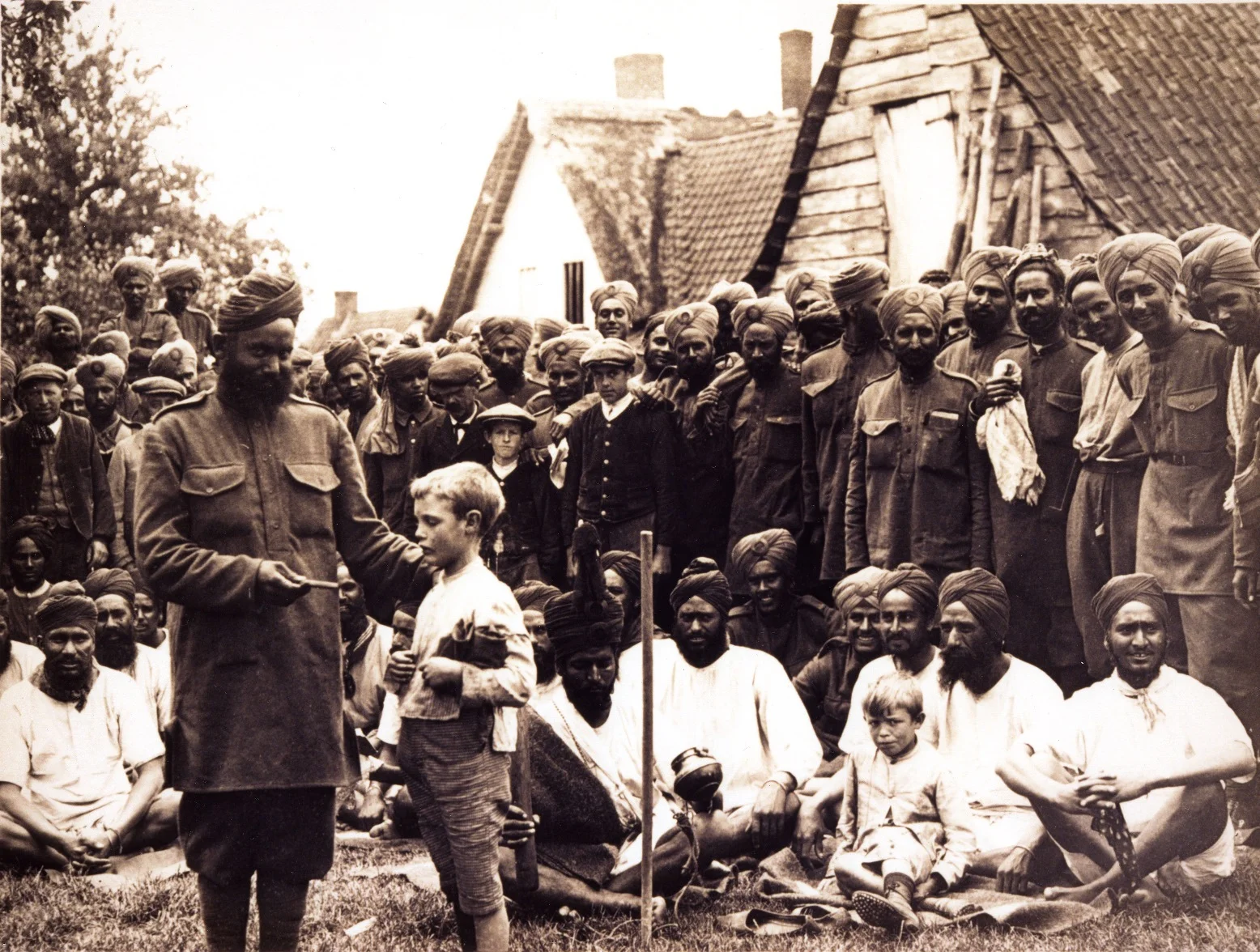 On Flanders Fields: Men of the 15th Sikh Regiment spend time with the locals in a Flanders village after weeks in the trenches of the Western Front, c. 1915. (Source: UKPHA Archive)