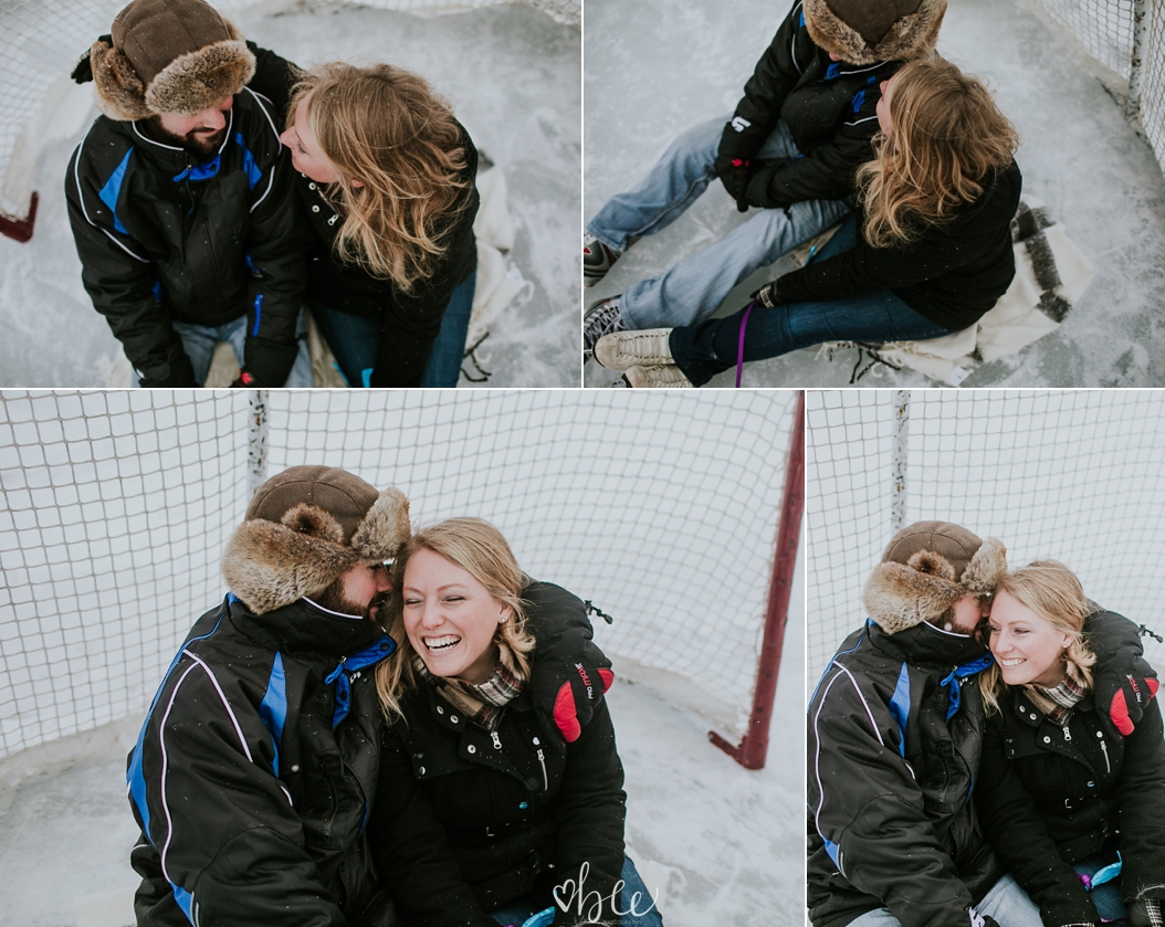 couple cuddling outside in winter on a skating pond