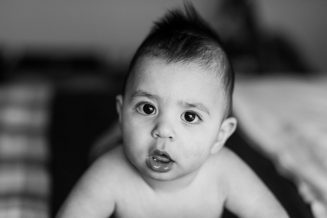  eight month old baby staring into camera in black and white 