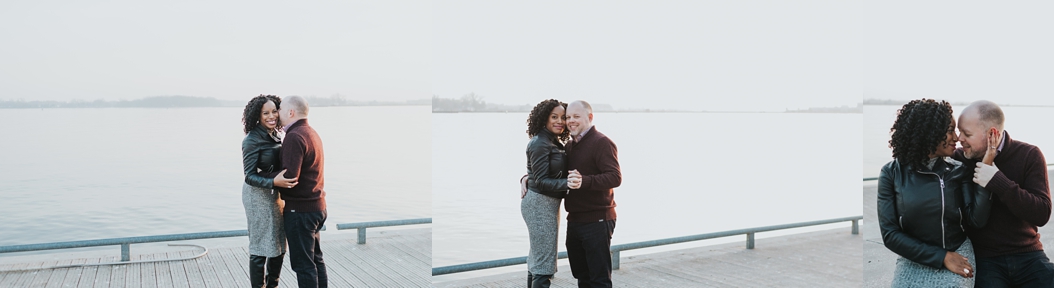  a couple cuddle on a pier in Toronto waterfront area 