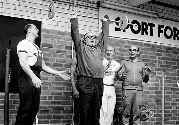 Denis Howell, Minister for Sport, lifting weights after opening a new sports and leisure centre in Birmingham, 26th Sept 1977