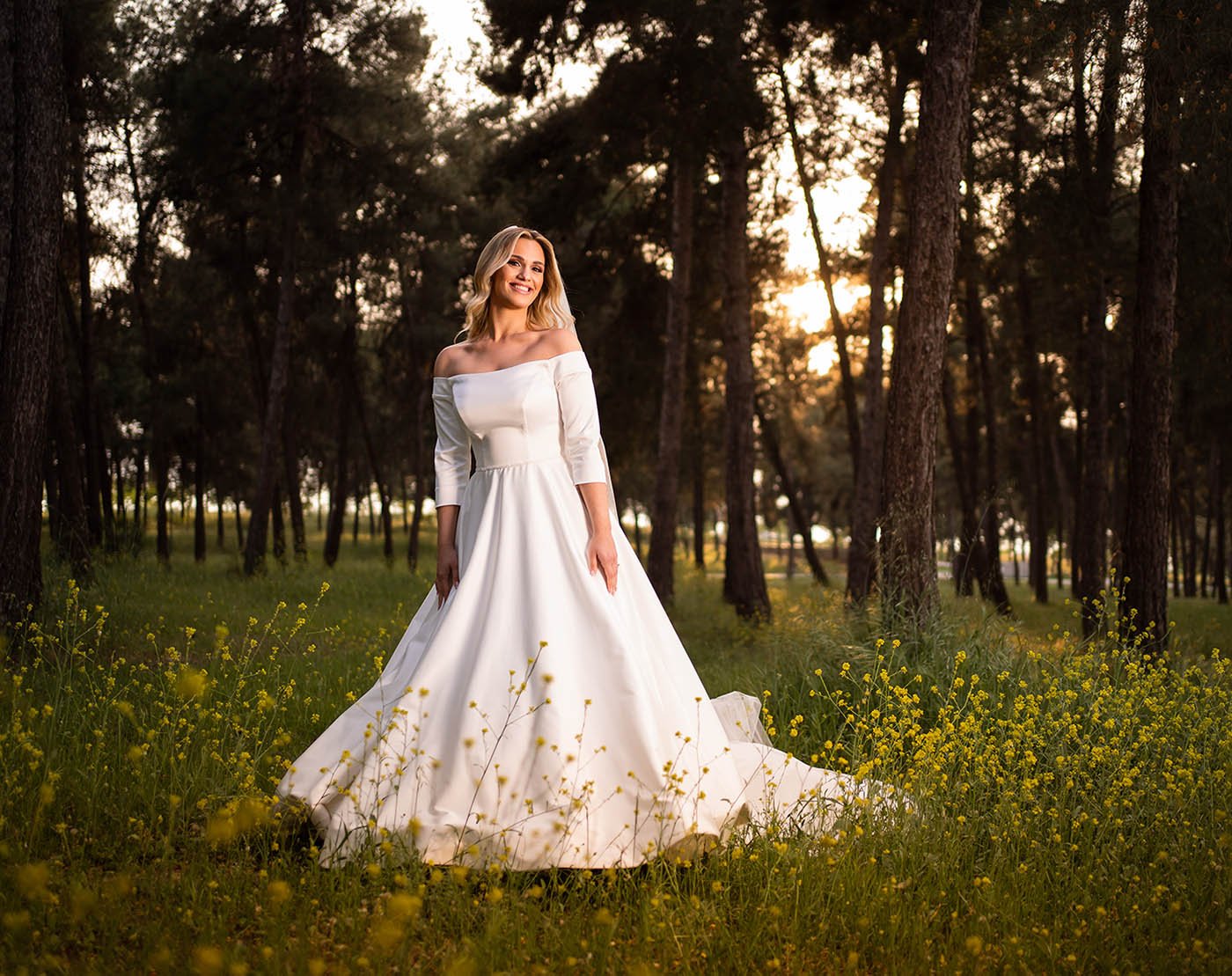  The bride looked stunning in her elegant wedding gown, which flowed gracefully behind her as she moved Her hair was styled in loose waves The soft light of the photo shoot illuminated her radiant smile and sparkling eyes The backdrop of the shoot wa