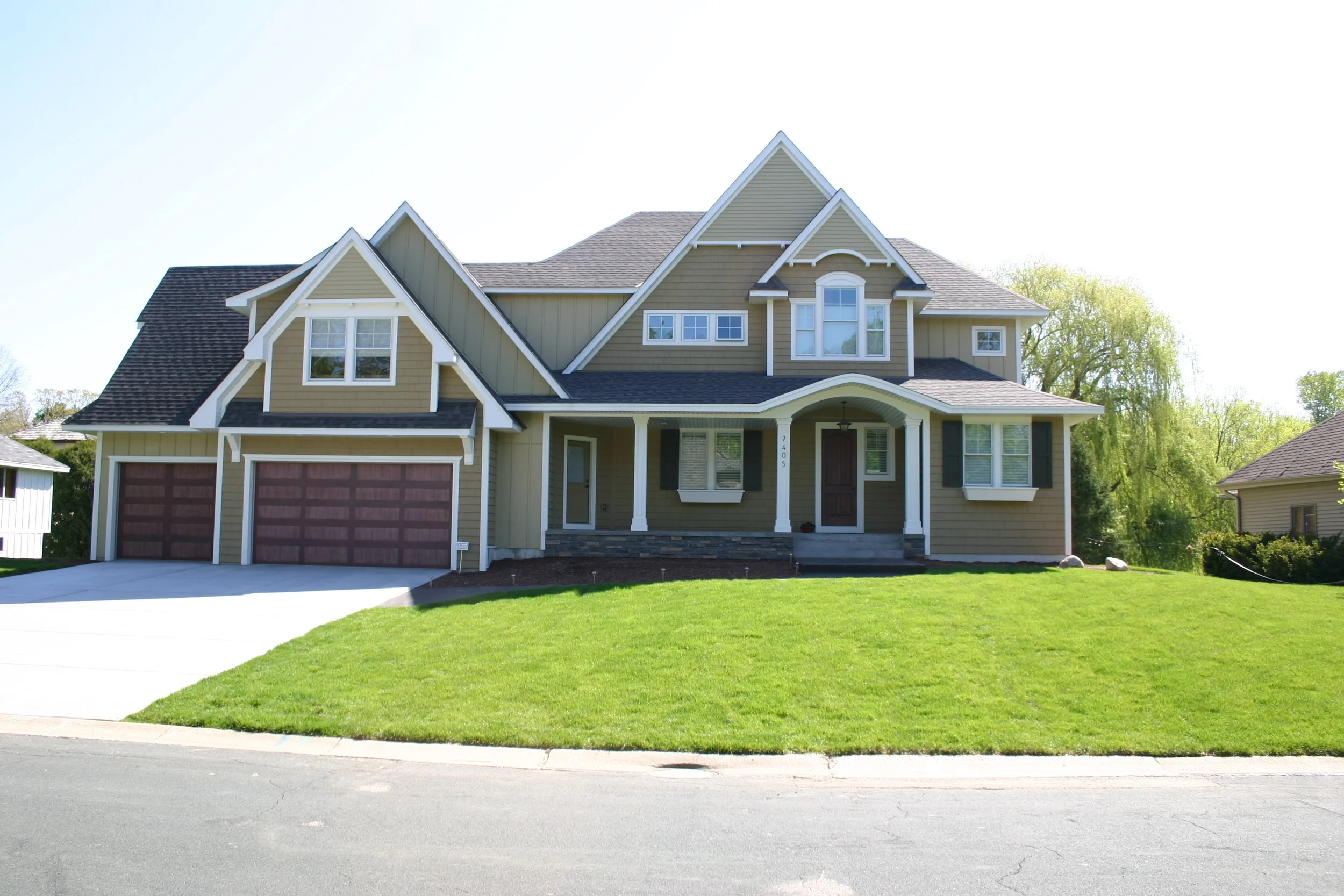 Before: Without any landscaping, this suburban home is adrift in endless turfgrass.