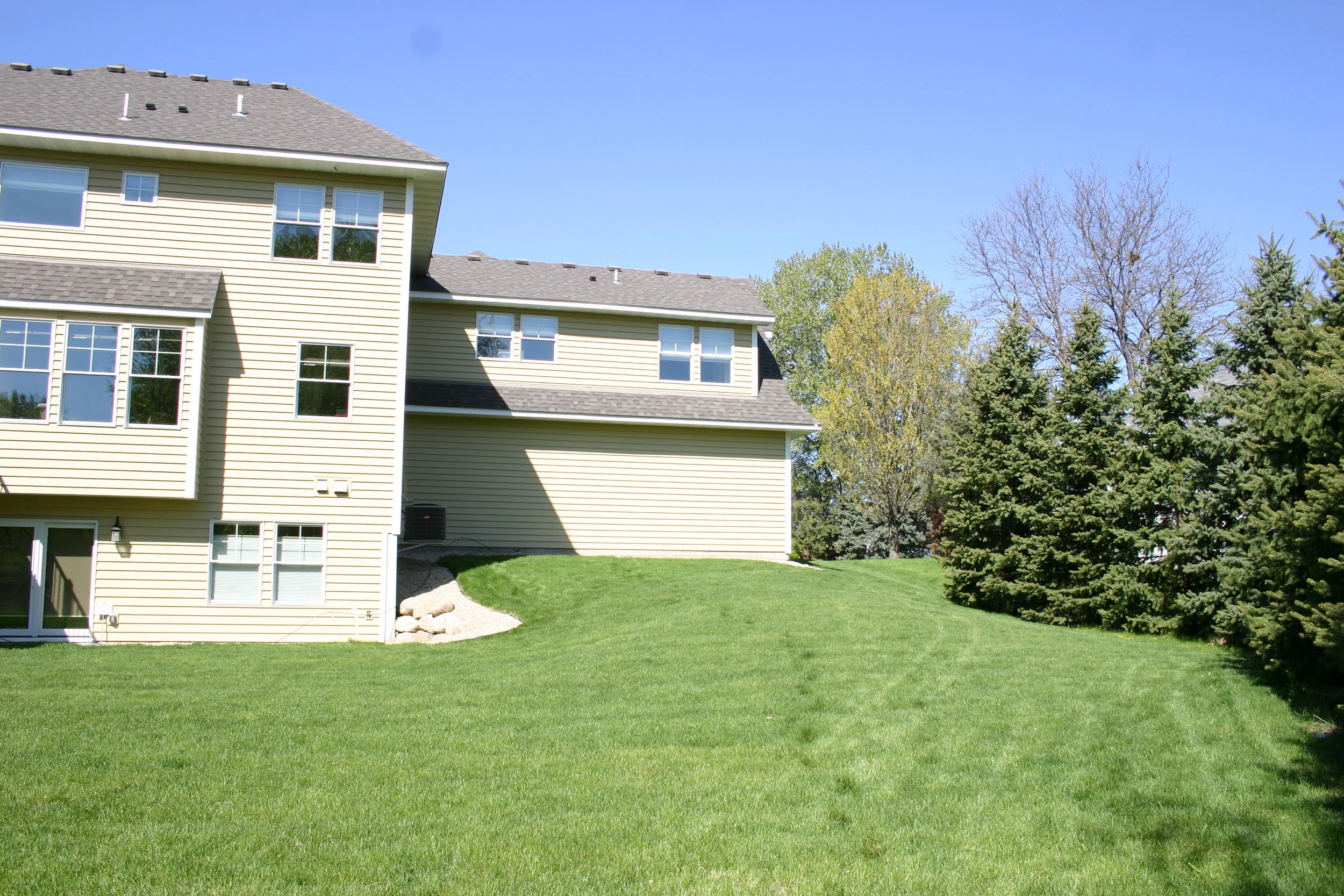 Before: Sharp angles and tall corners dominate the backyard.