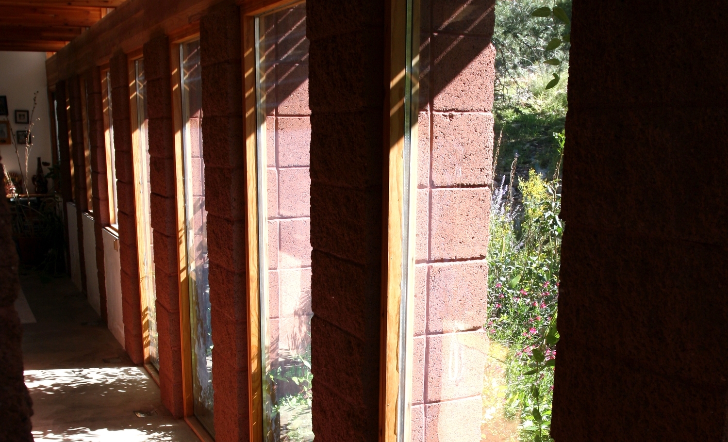 Passive solar glazing charges internal thermal mass