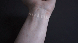 The small projector displays the set of instructions directly on the user's wrist