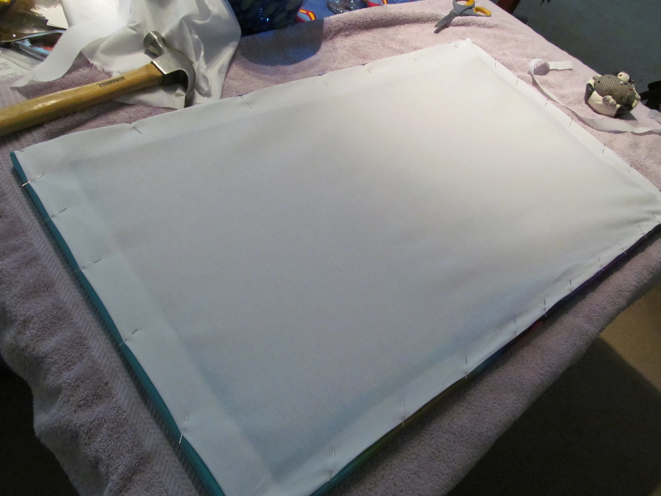 A muslin backing is sewn on to protect the silk.