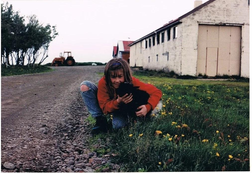 Me making friends with a motherless Icelandic lamb.&nbsp; (And the day I became a vegetarian!)