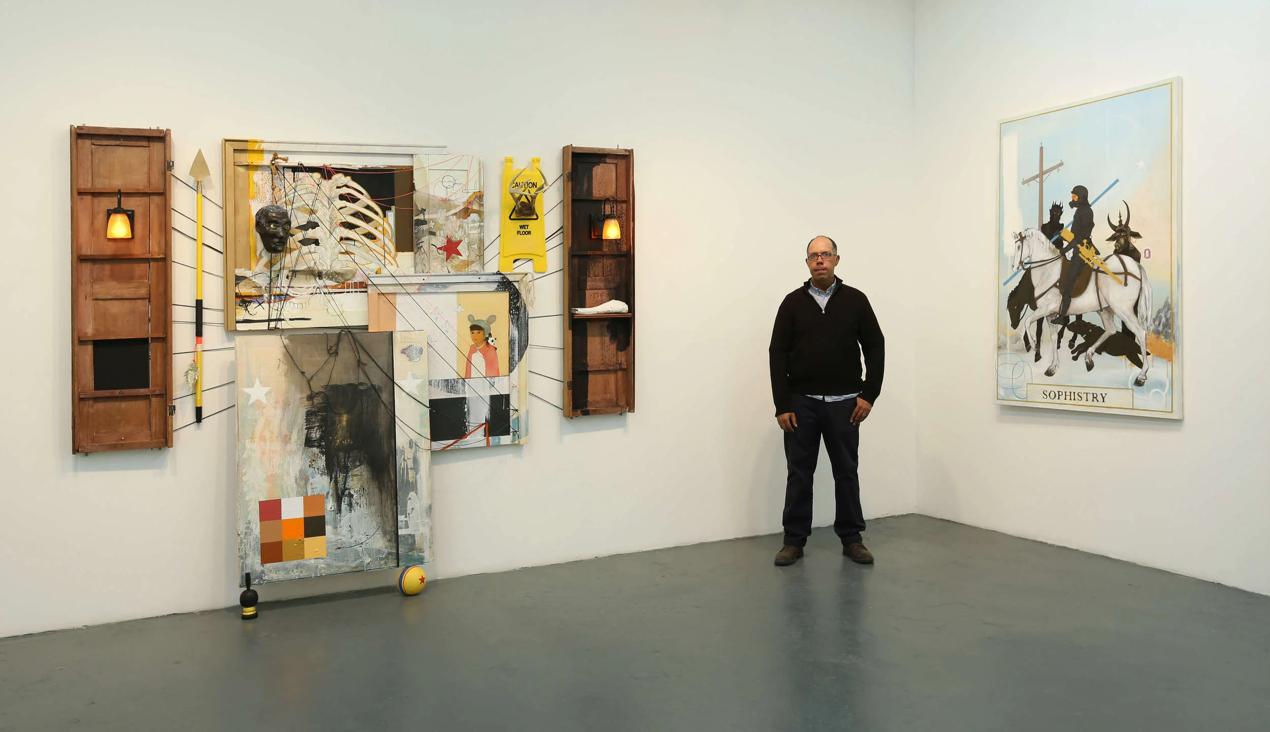 The artist pictured with "Untitled" and "Sophistry".