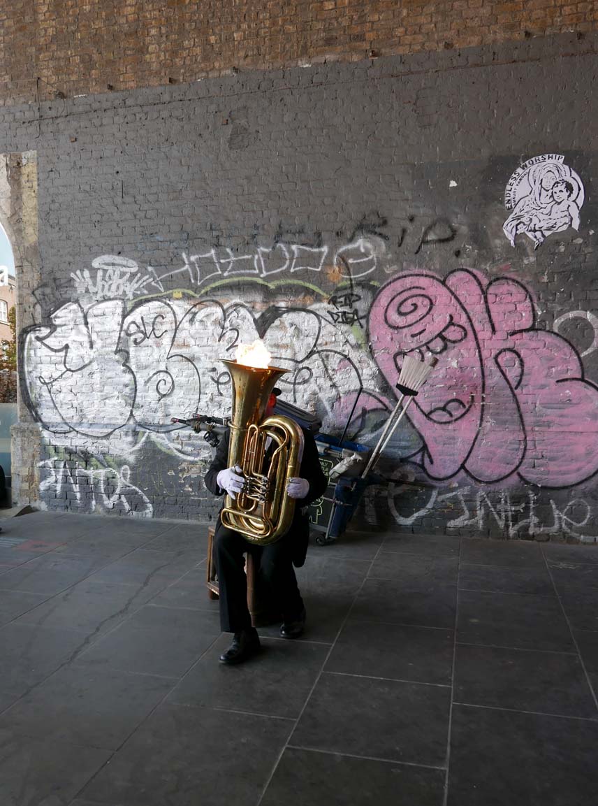 Street musician blowing fire