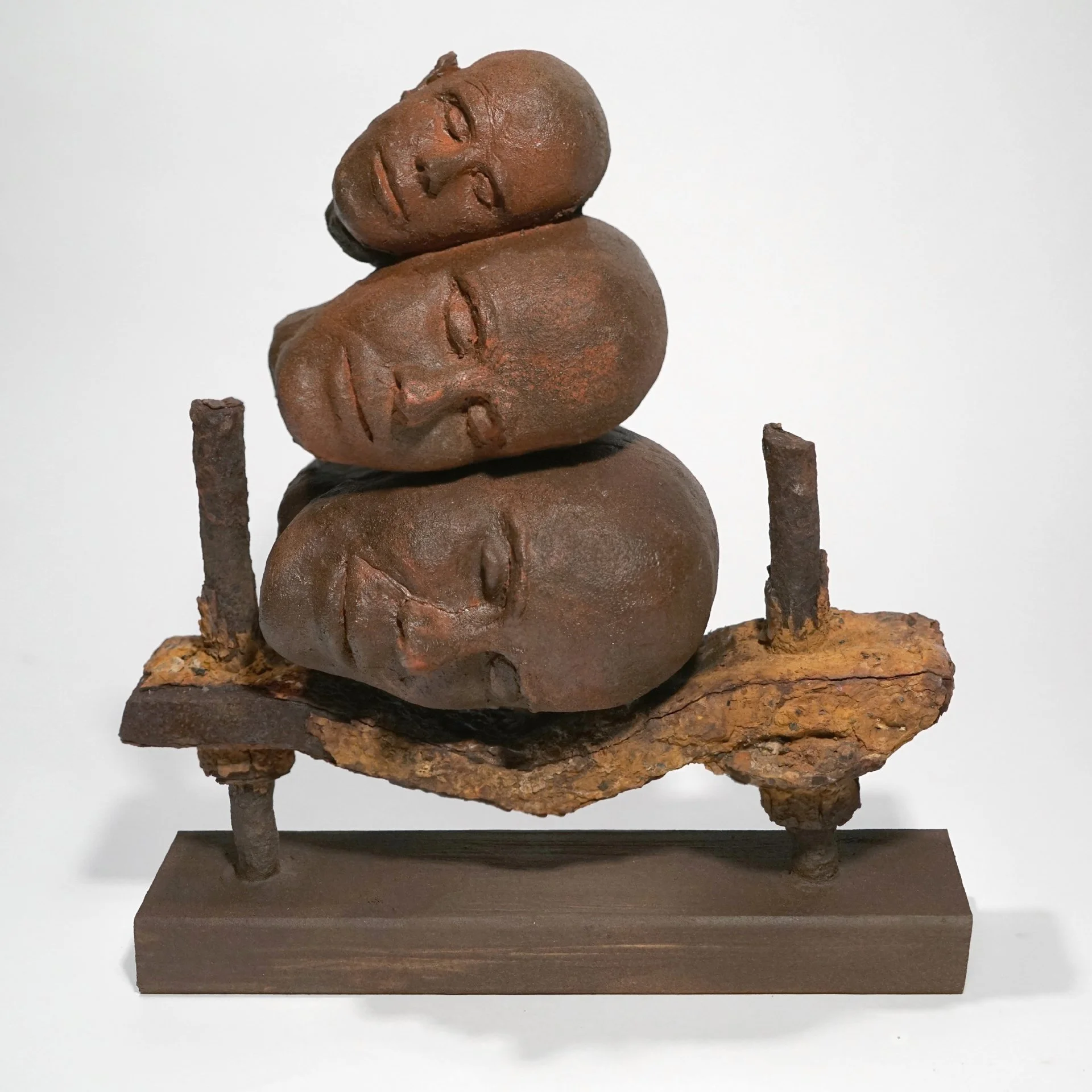 Pillow, 2019. Clay, paint, found metal object, wood. Approx. 16" high