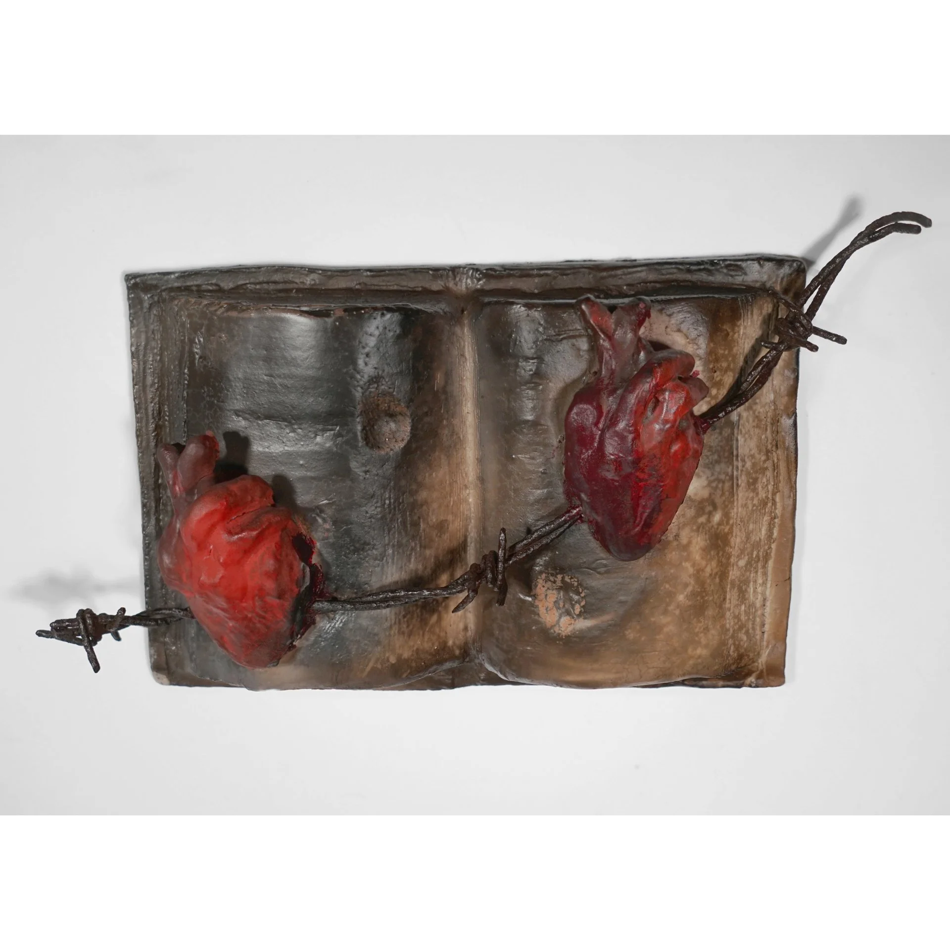 Librito de Corazones (Little Book of Hearts), 2018. Clay, underglaze, terra sigillata, barbed wire. Approx. 6" h x 9" w