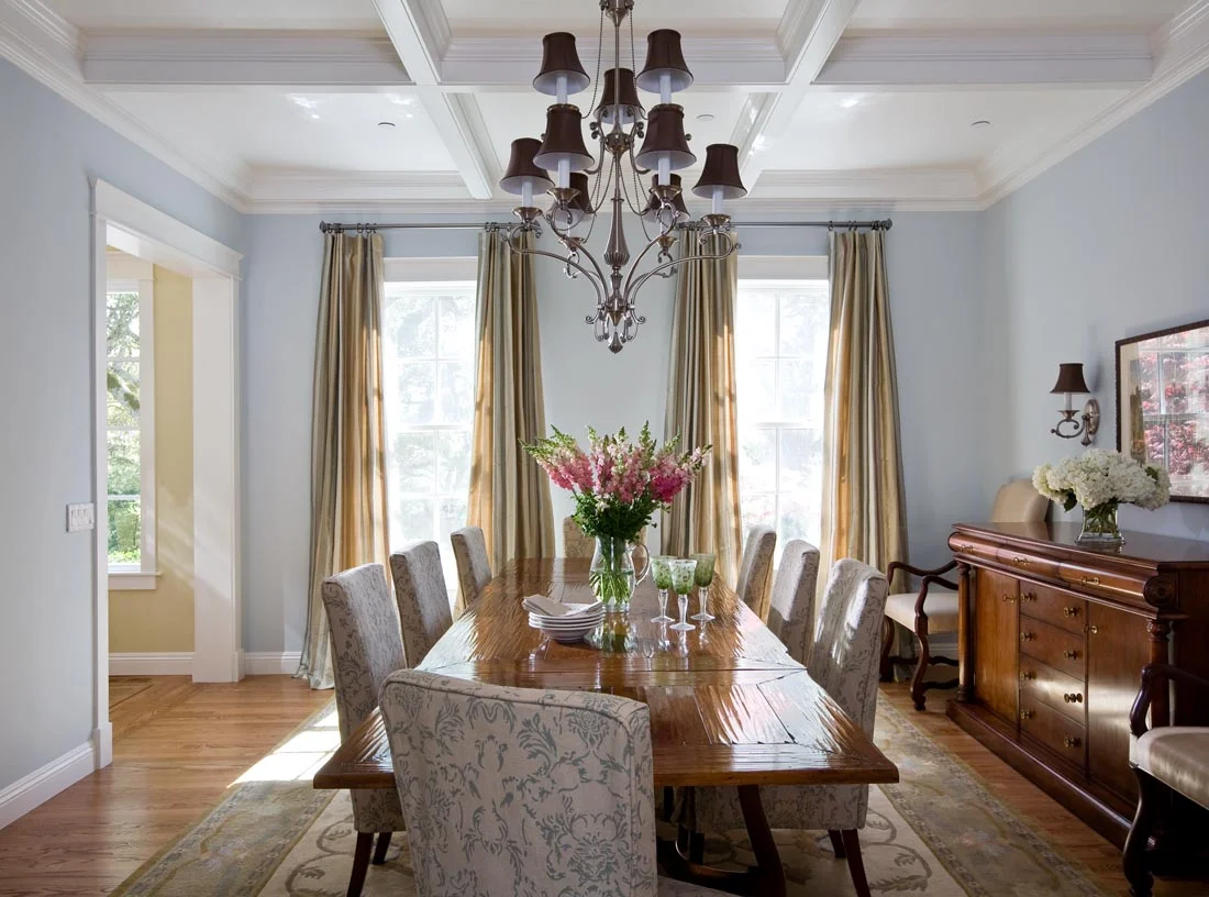 Traditional dining room with coffered ceiling detail.