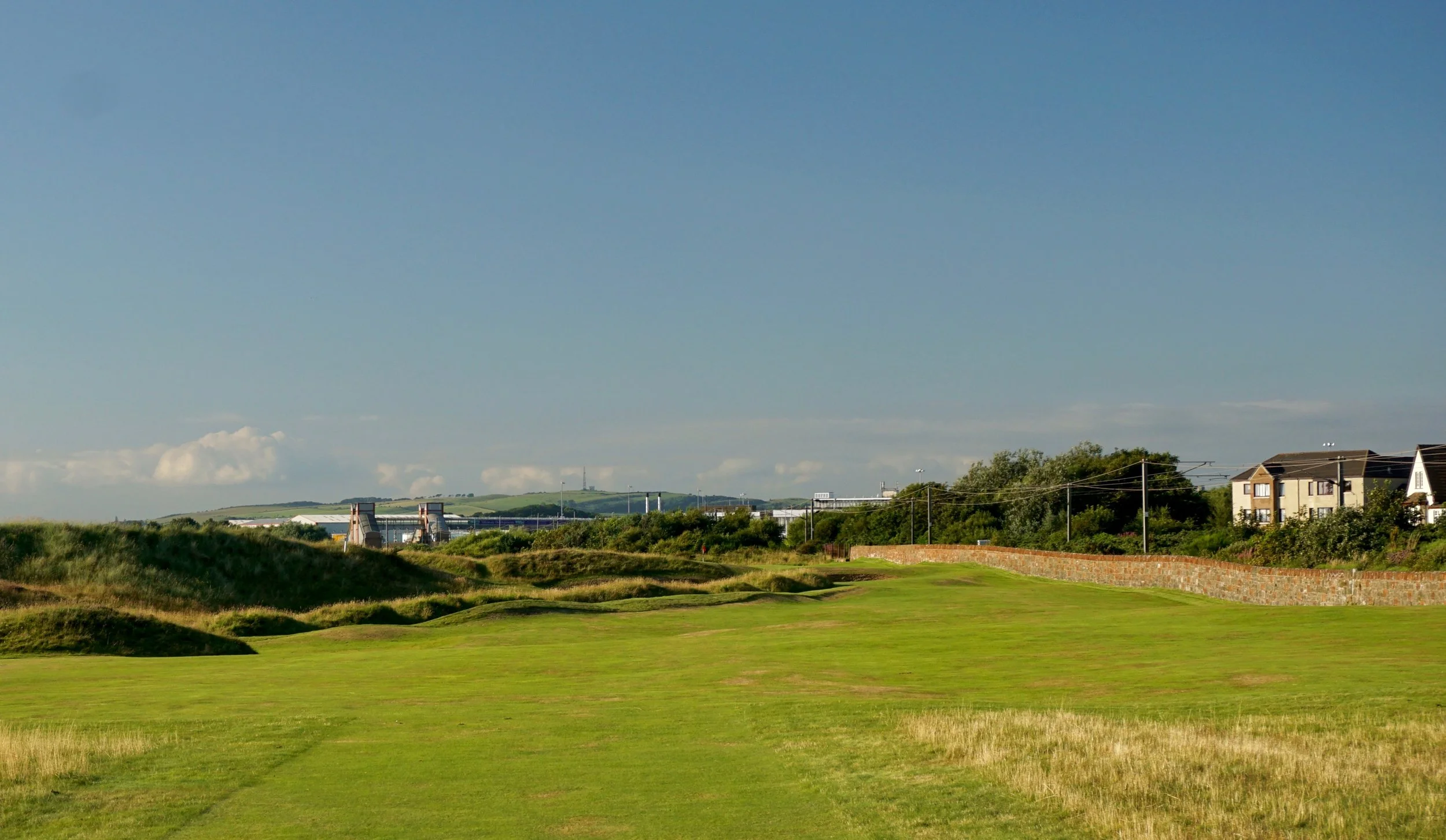 The closer to the railway, the better the angle into the green. The red flag at the green can just be seen in the center behind a dune.