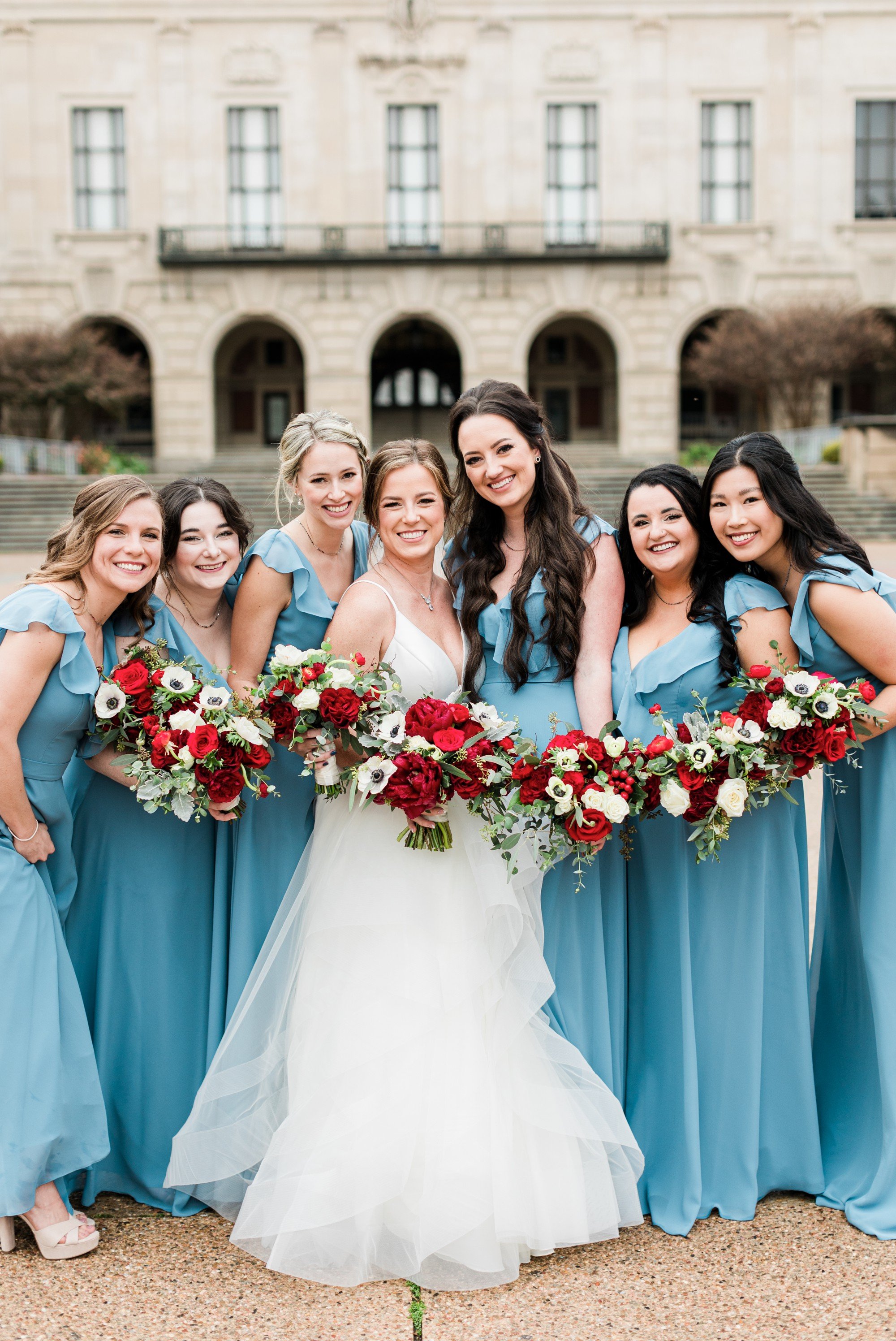 blue bridesmaids dresses with red flowers