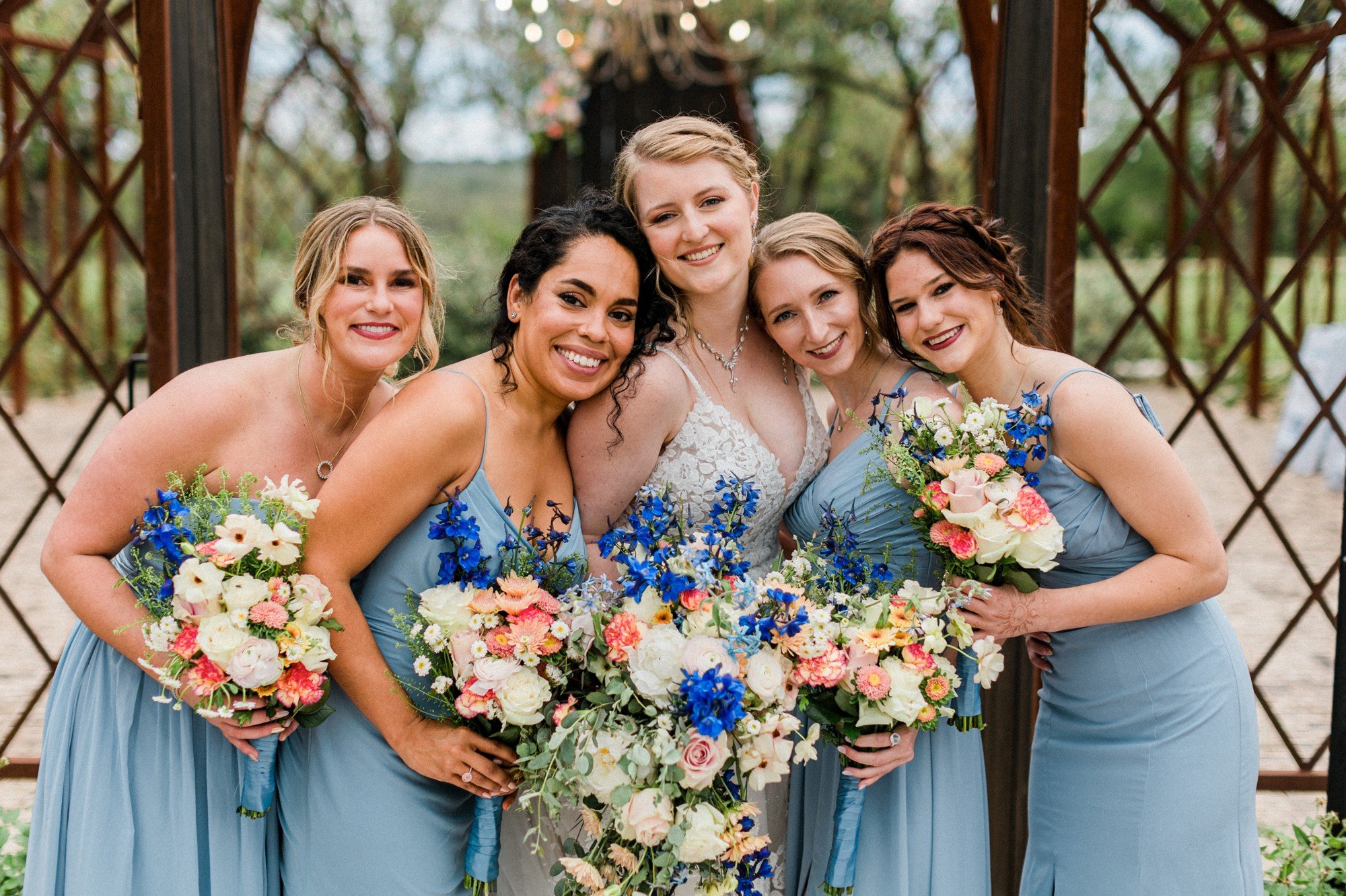 dusty blue bridesmaid dress with colorful spring flowers