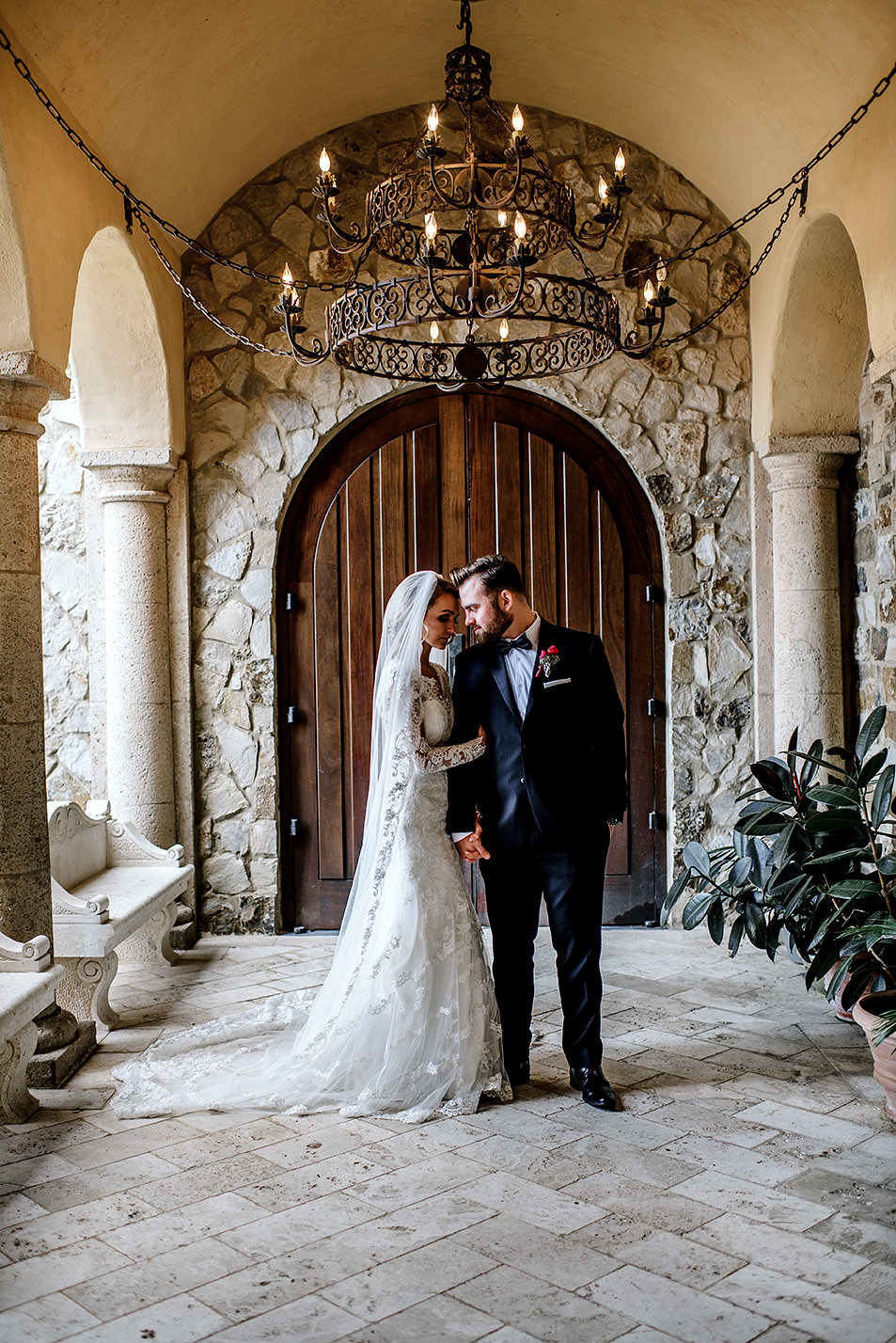 Bride and Groom standing in a beautiful hallway at Bella Collina Florida
