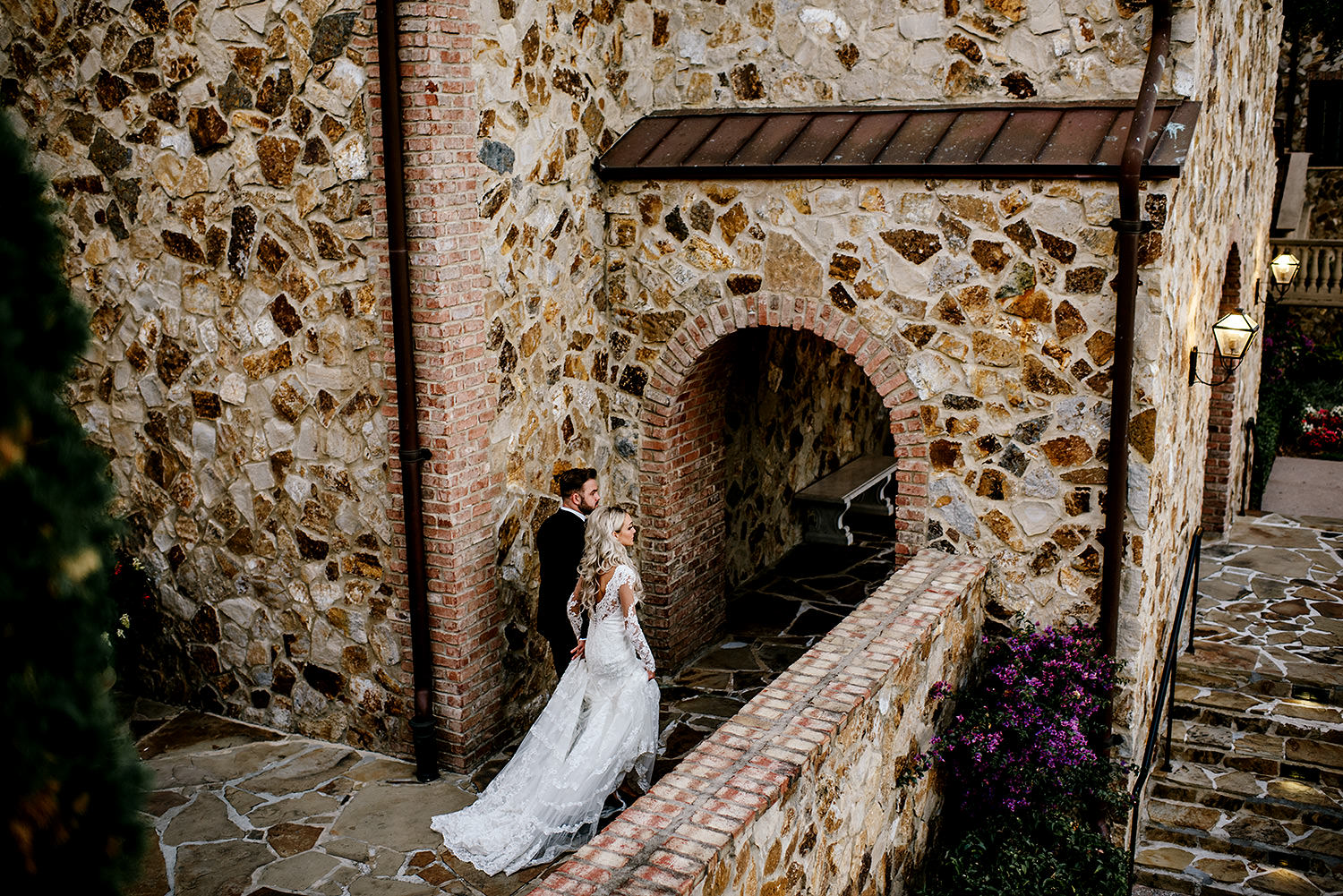 Bride and groom walking through the beautiful cobble stoned villa at Bella Collina Florida