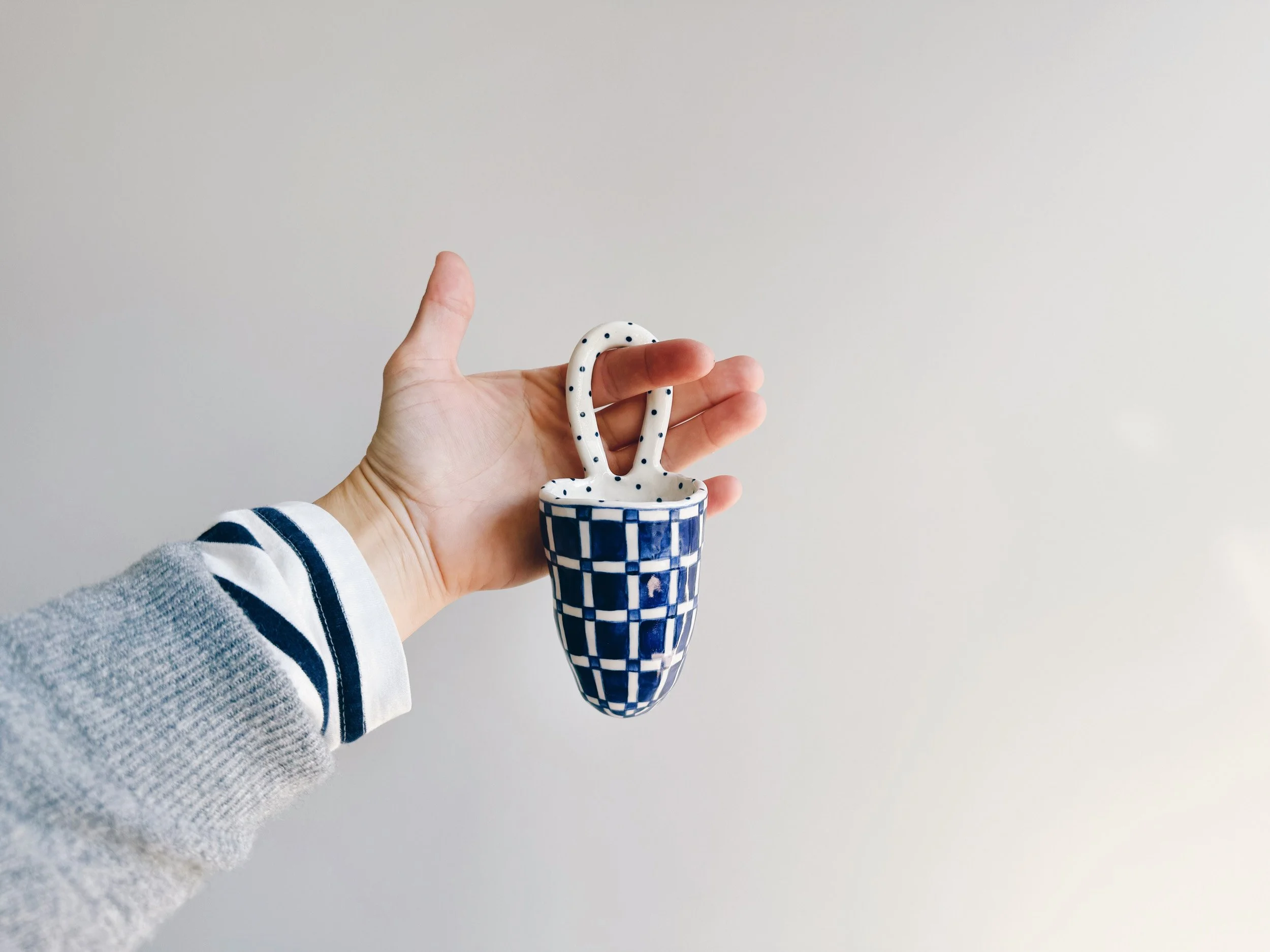 Blue and white, handmade ceramic vessel.
