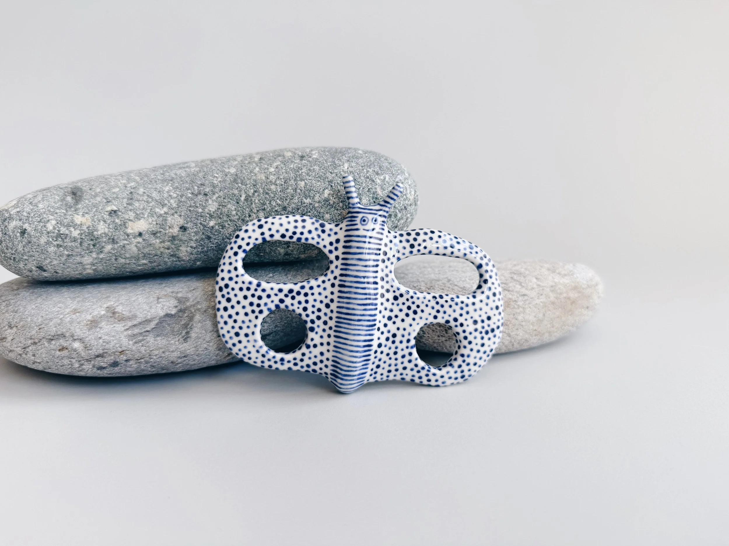 Blue and white, handmade ceramic butterfly.