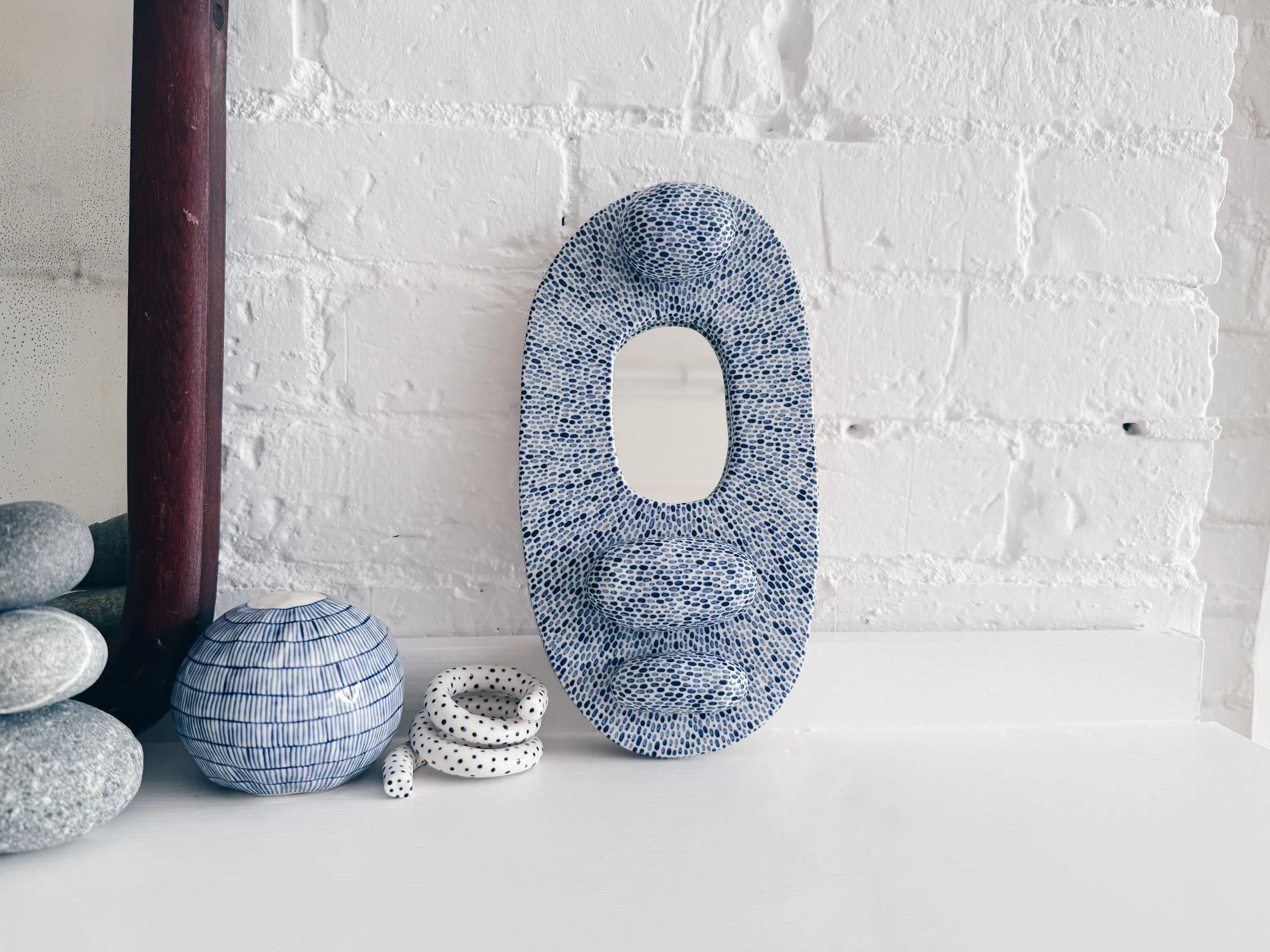 Blue and white, handmade ceramic mirror.