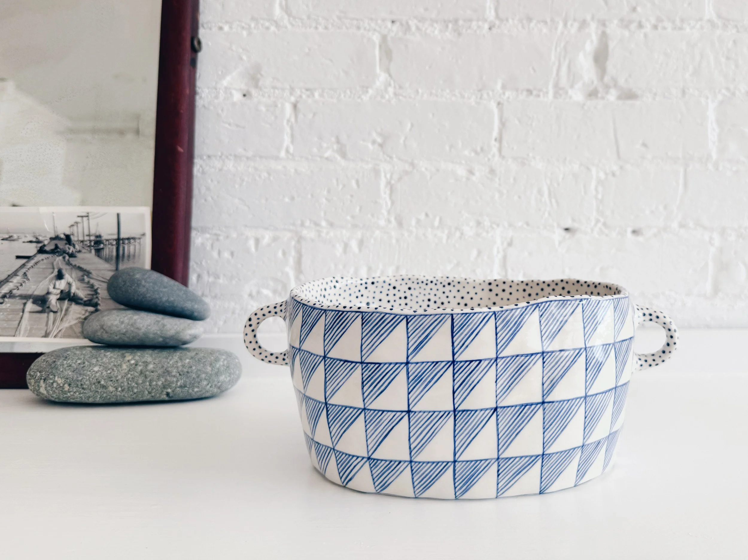 Blue and white, handmade ceramic vessel.