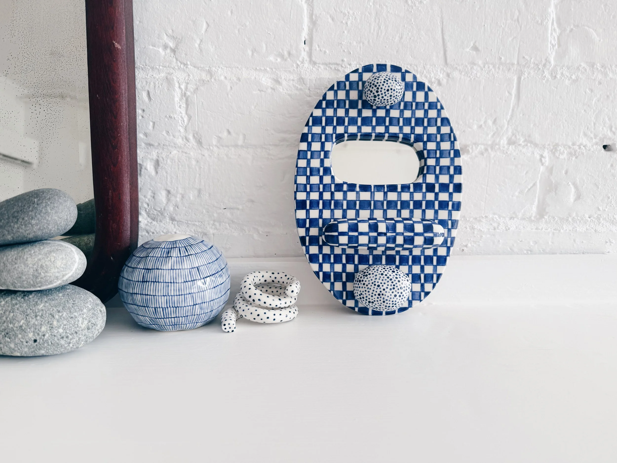 Blue and white, handmade ceramic mirror.