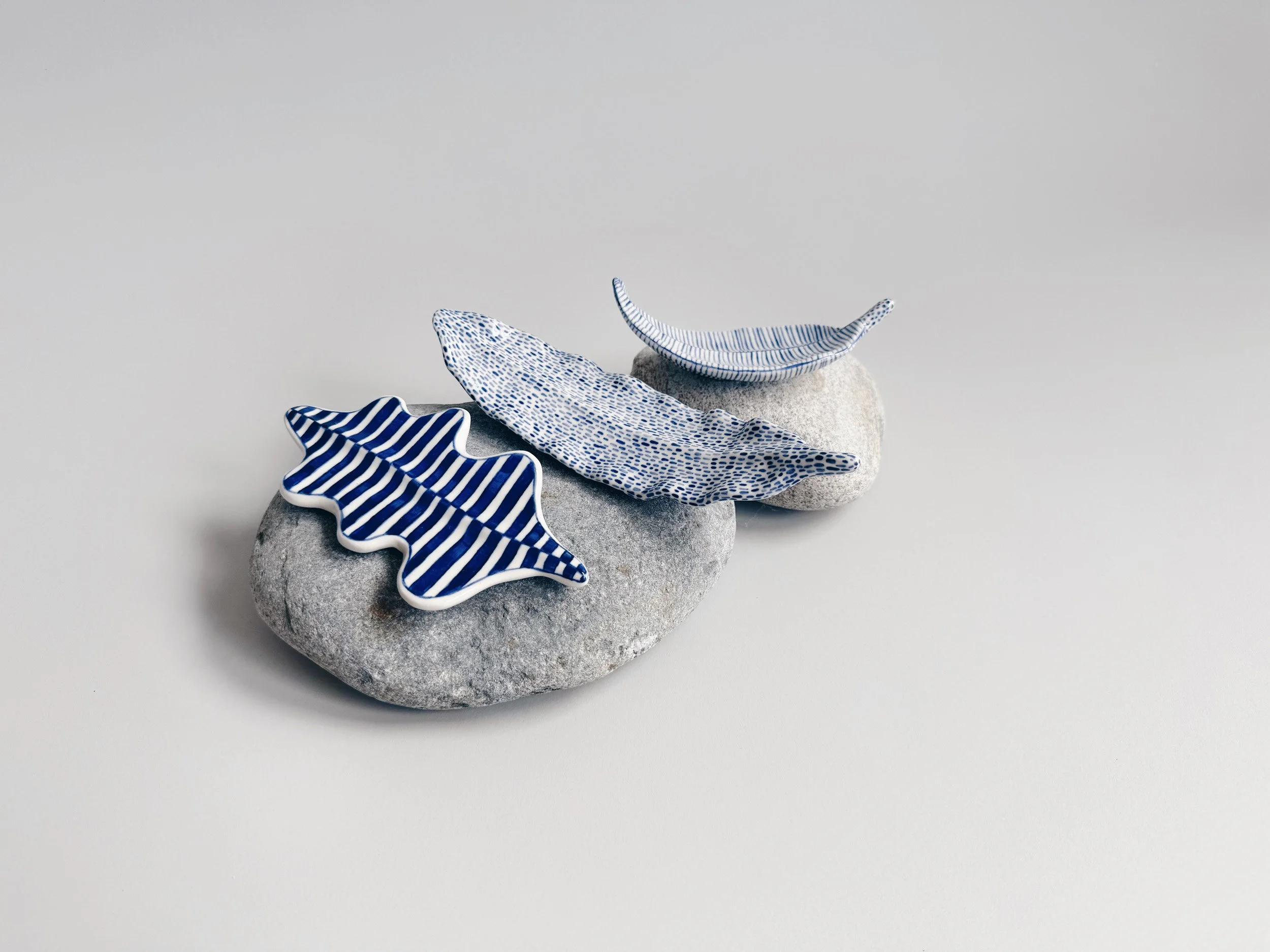 Blue and white, handmade ceramic leaf.