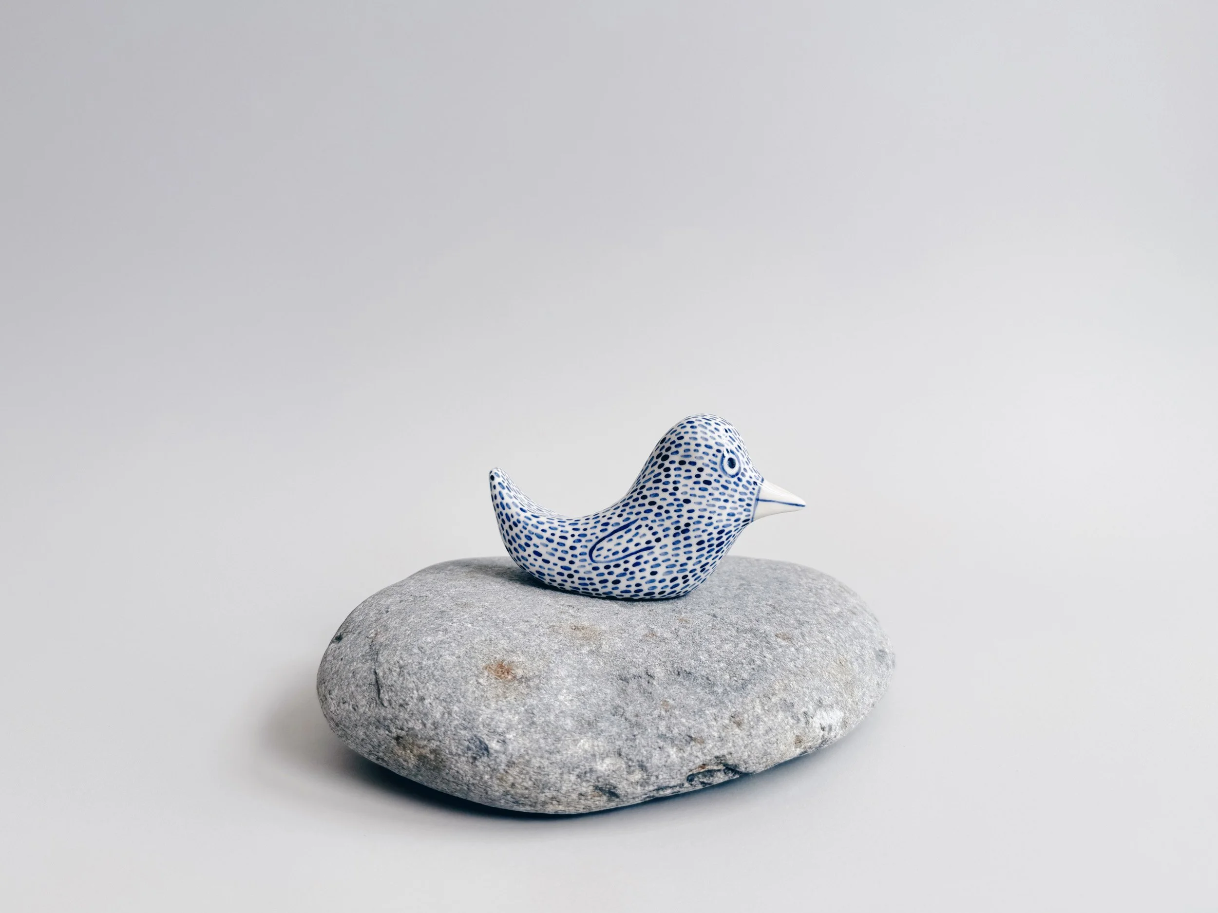 Blue and white, handmade ceramic bird.