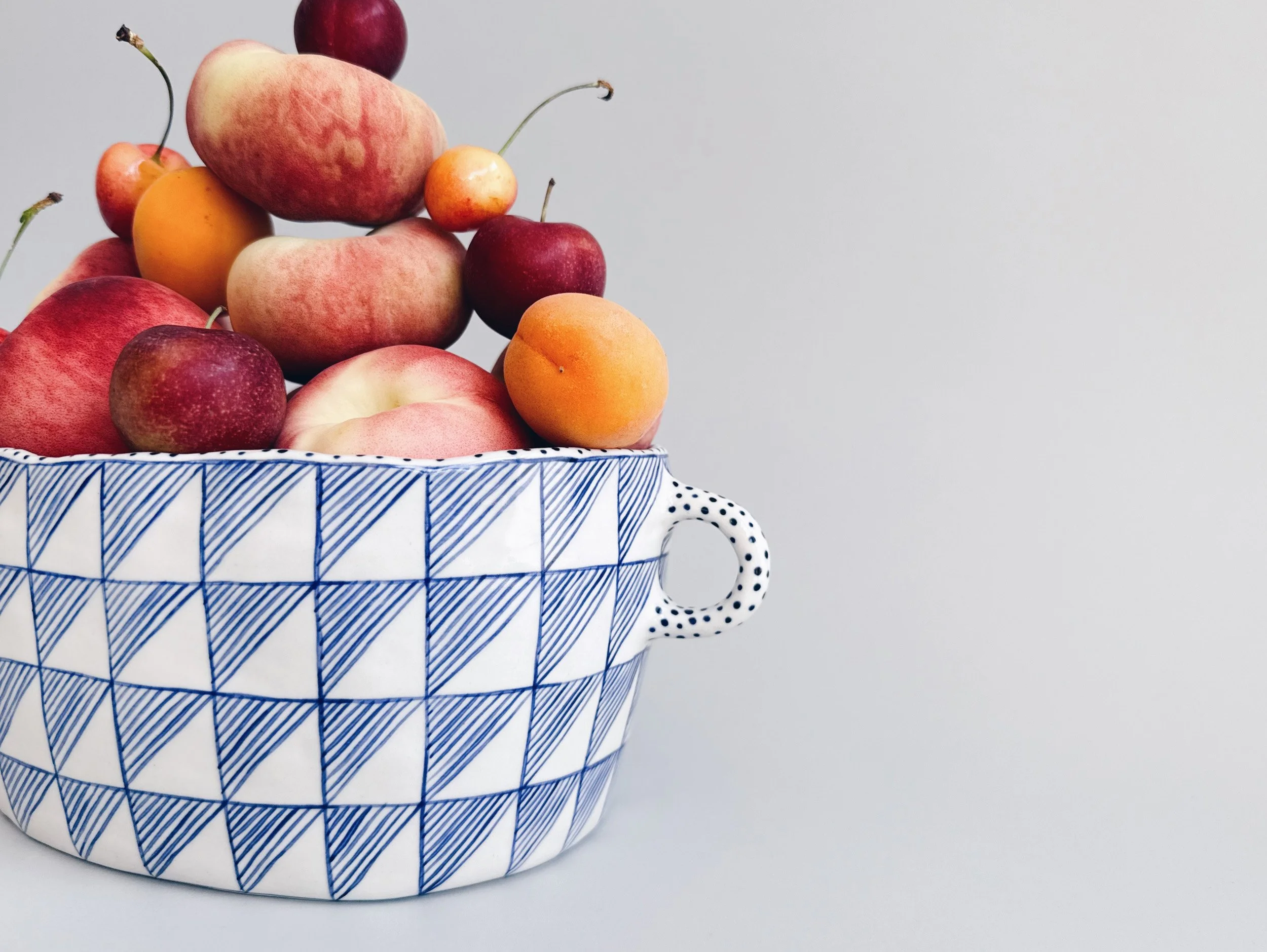 Blue and white, handmade ceramic vessel.