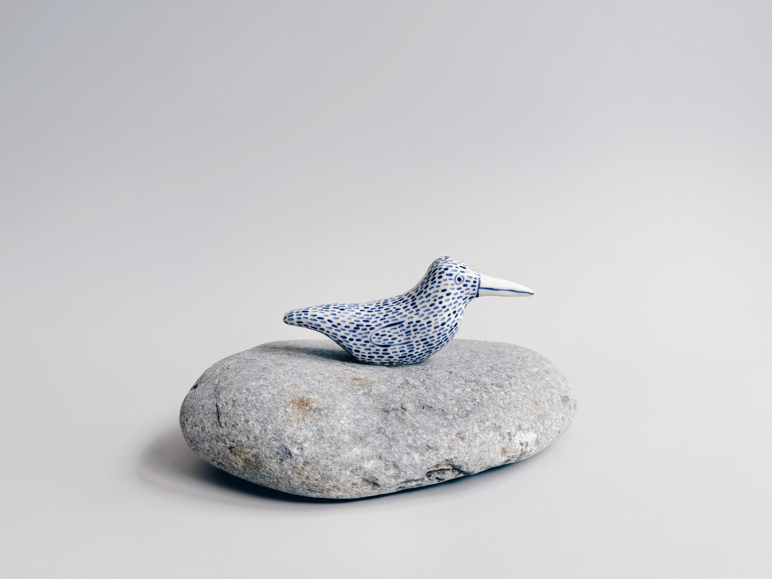 Blue and white, handmade ceramic bird.