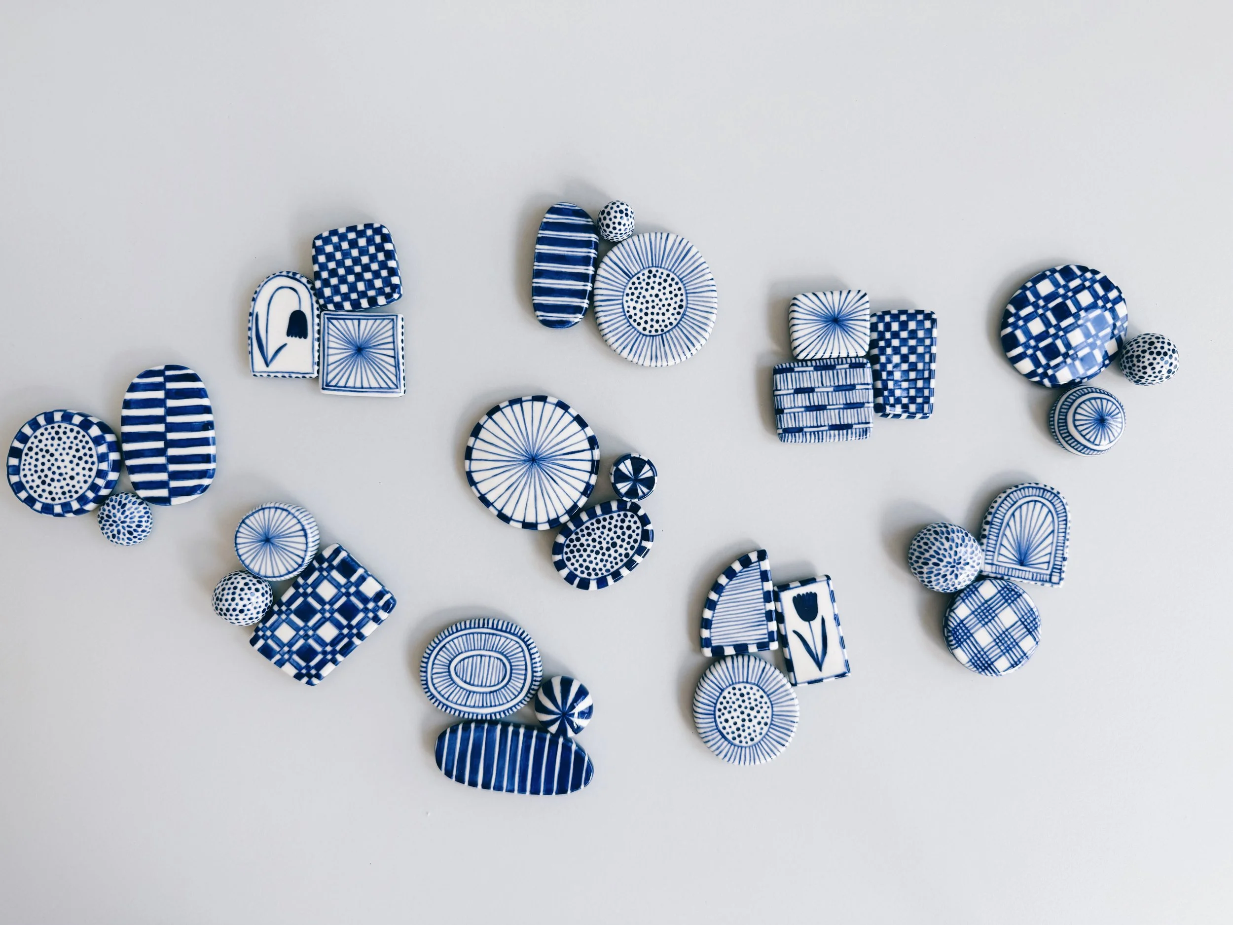 Blue and white, handmade ceramic magnets.