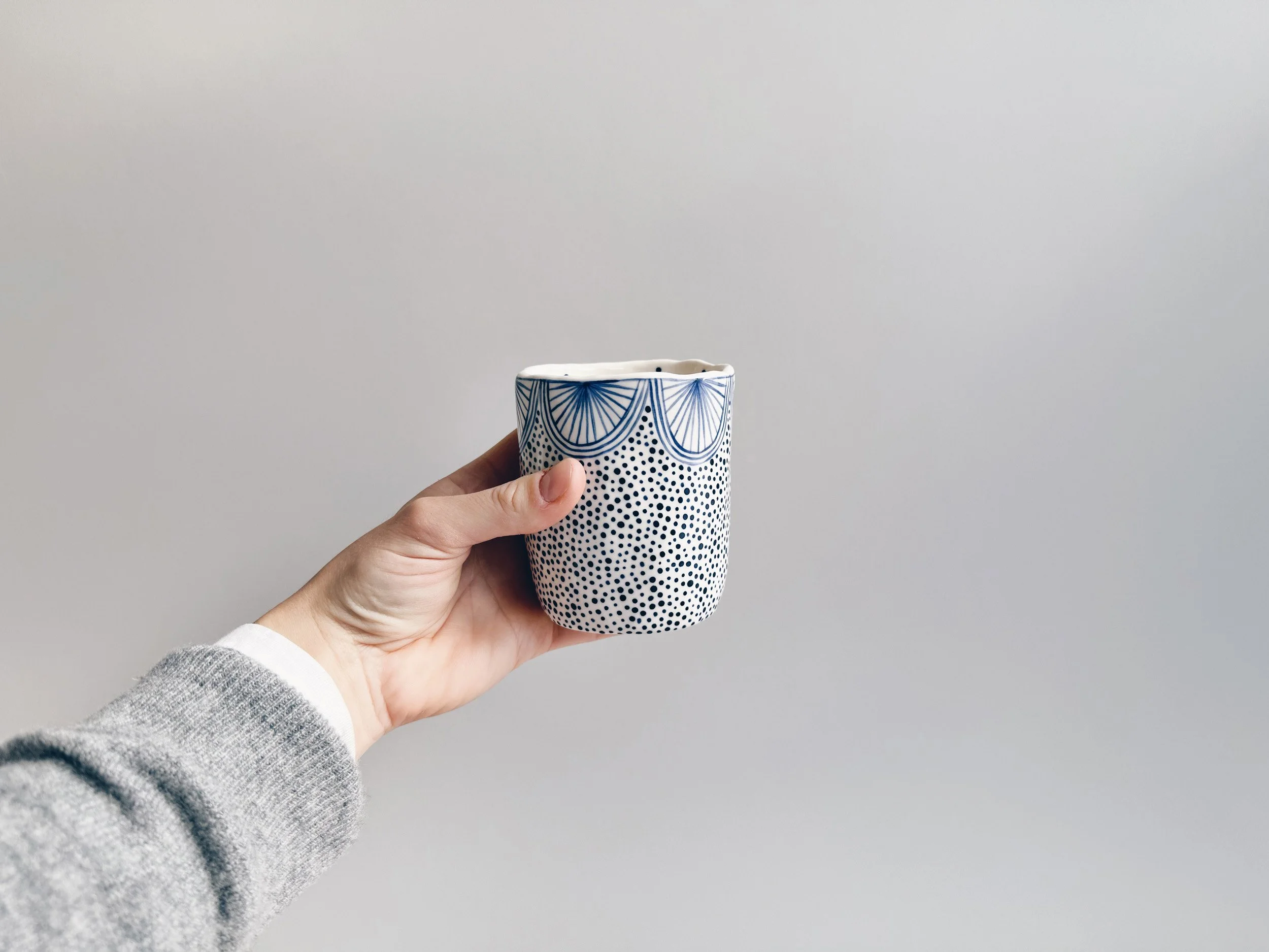 Blue and white, handmade ceramic cup.