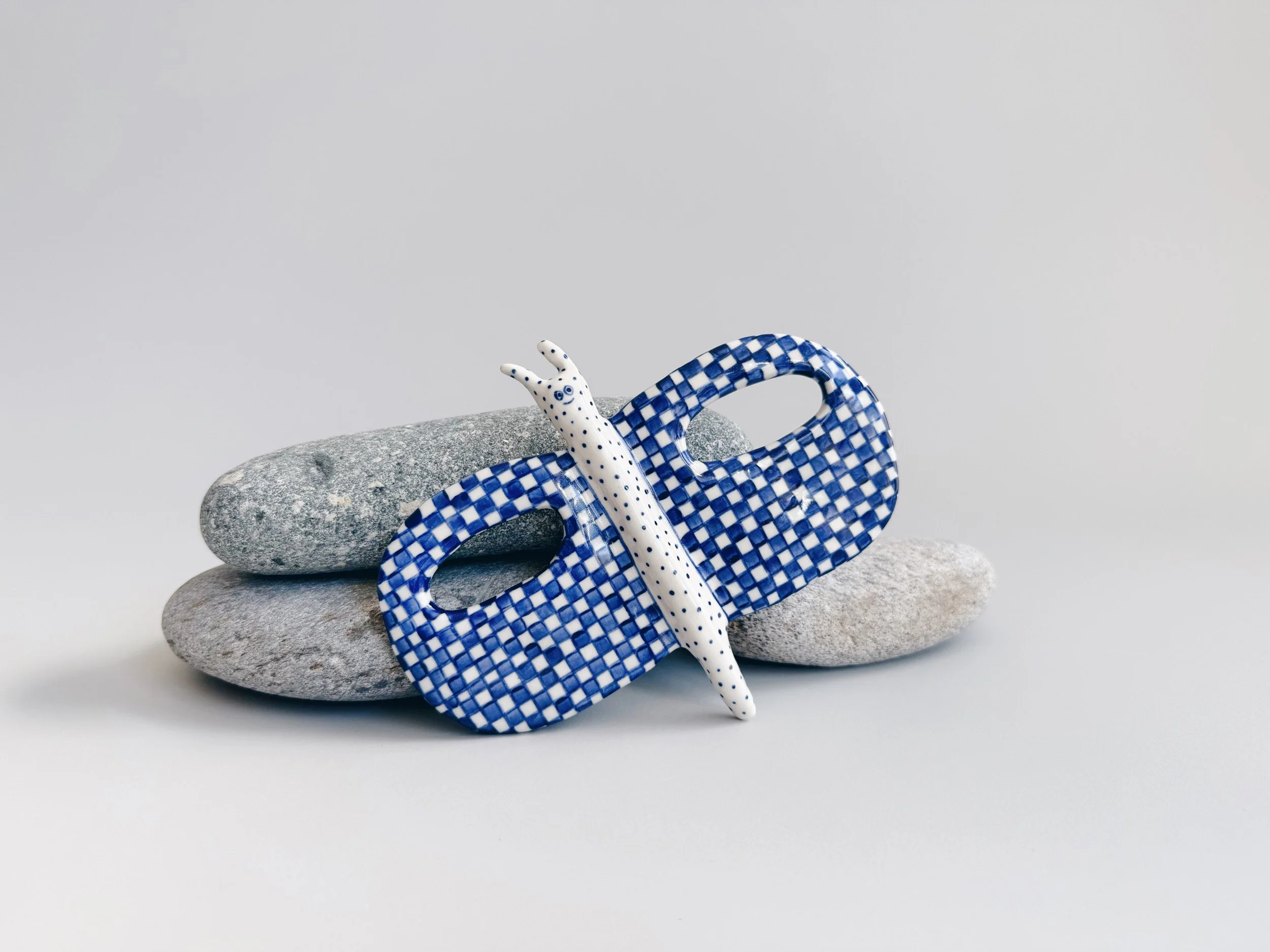 Blue and white, handmade ceramic butterfly.