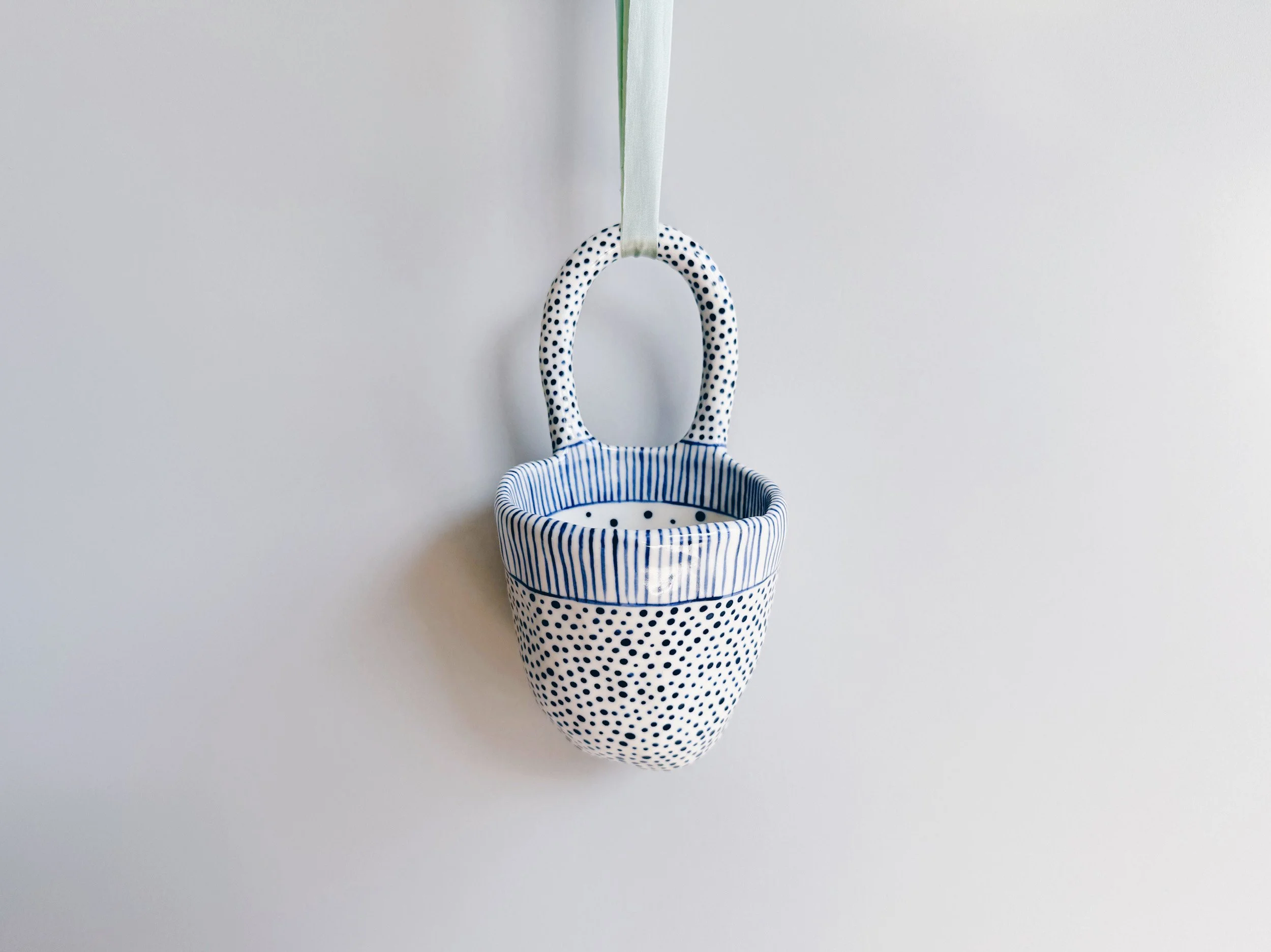 Blue and white, handmade ceramic vessel.