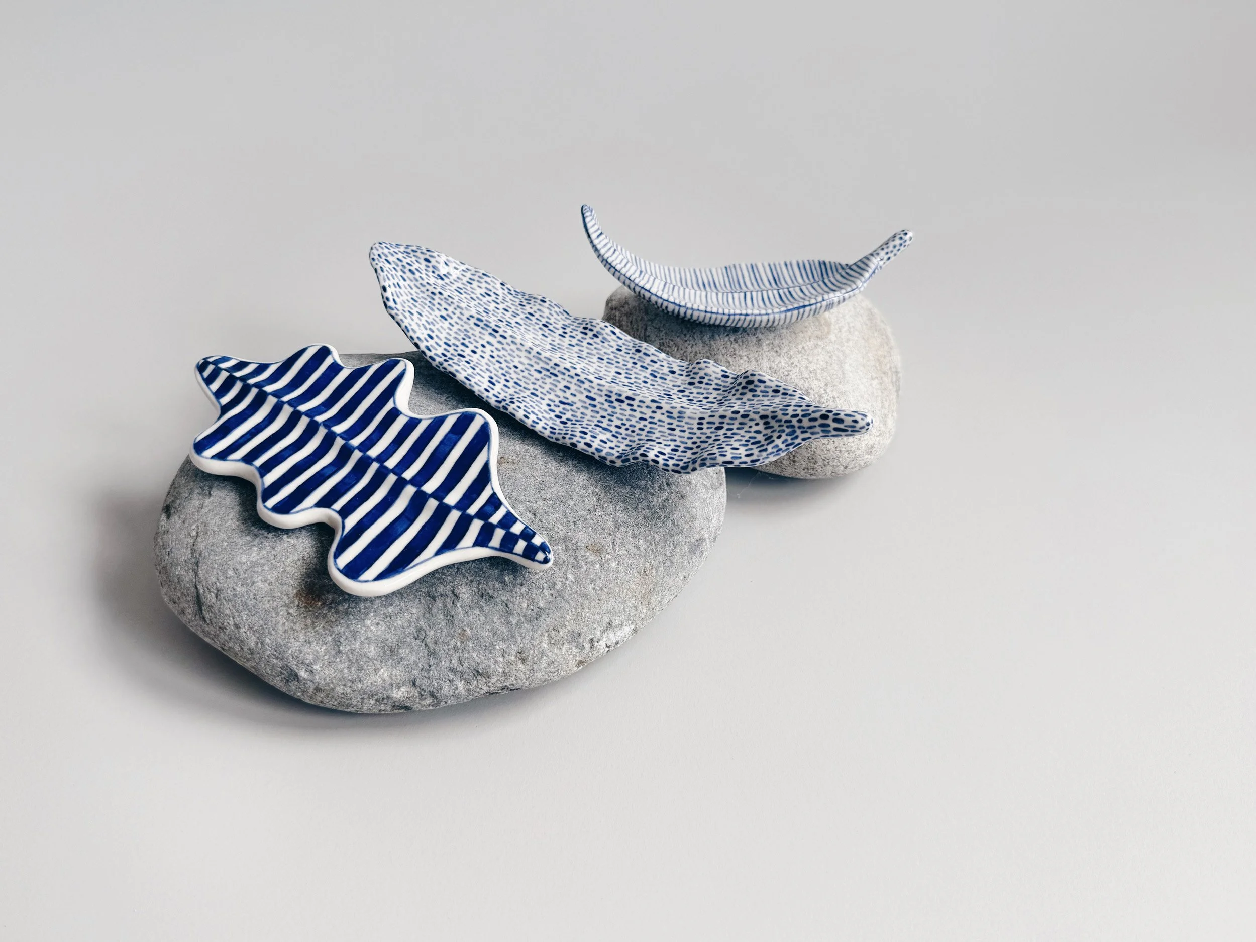 Blue and white, handmade ceramic leaf.