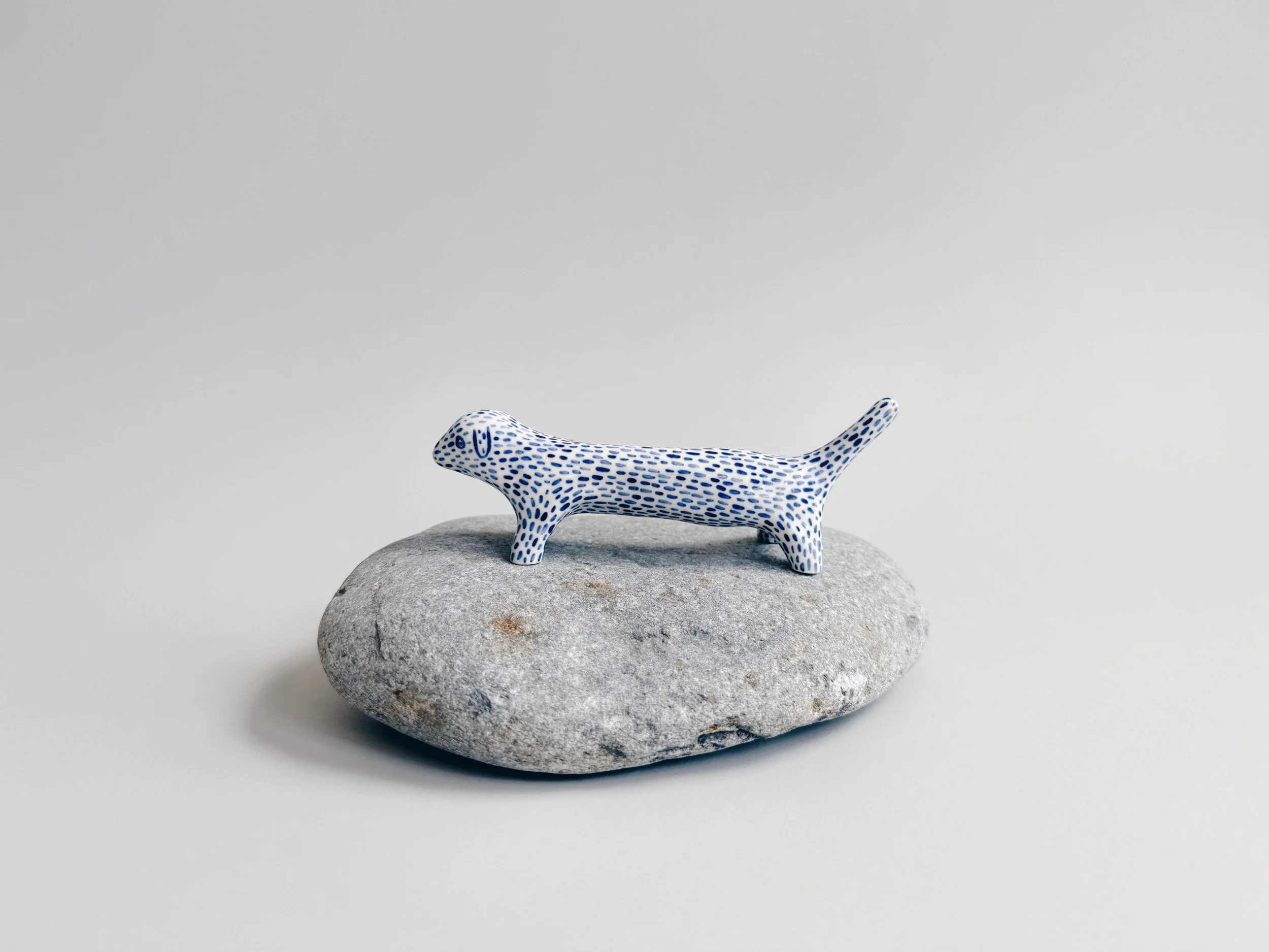 Blue and white, handmade ceramic dog.