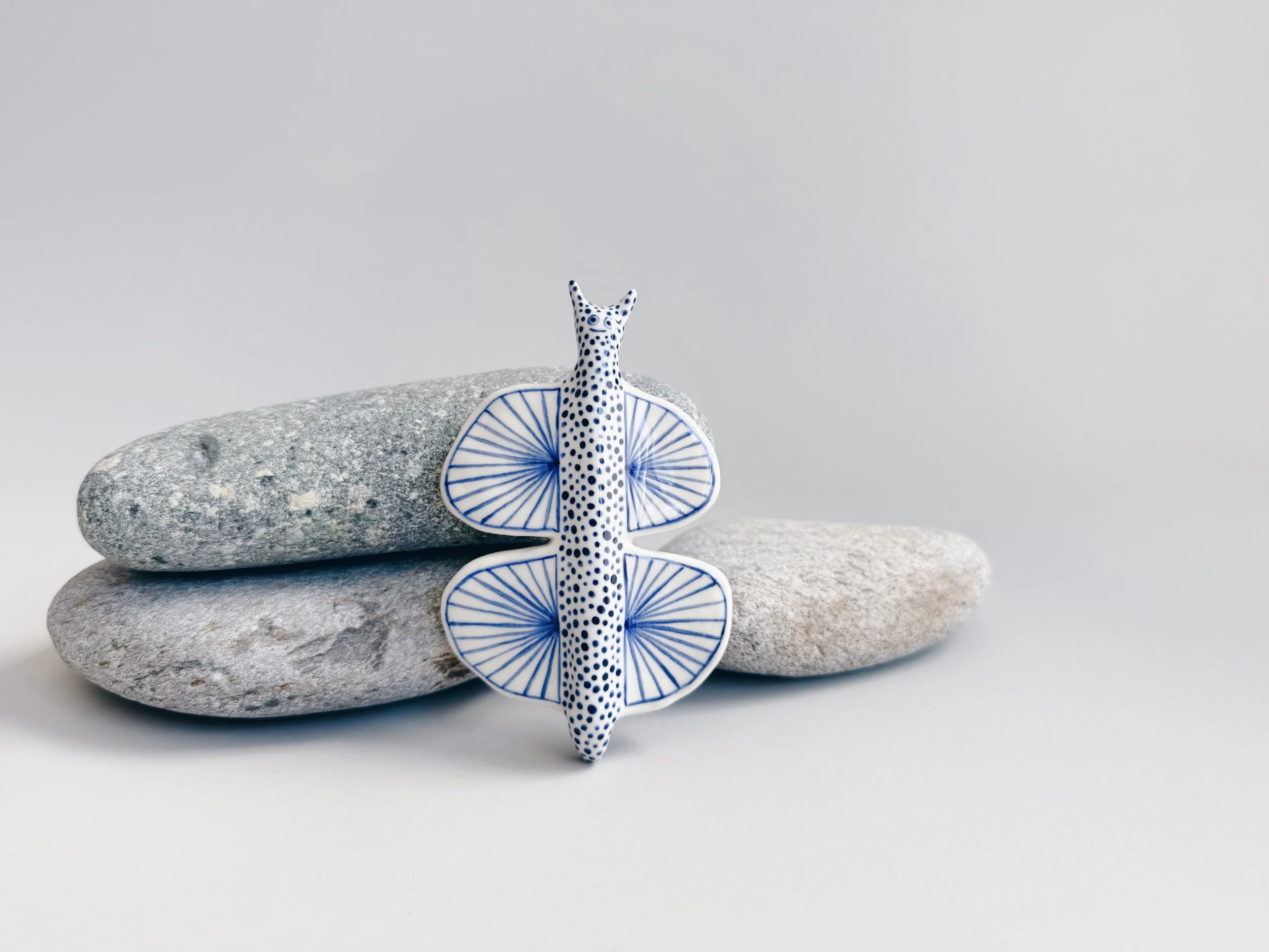 Blue and white, handmade ceramic butterfly.