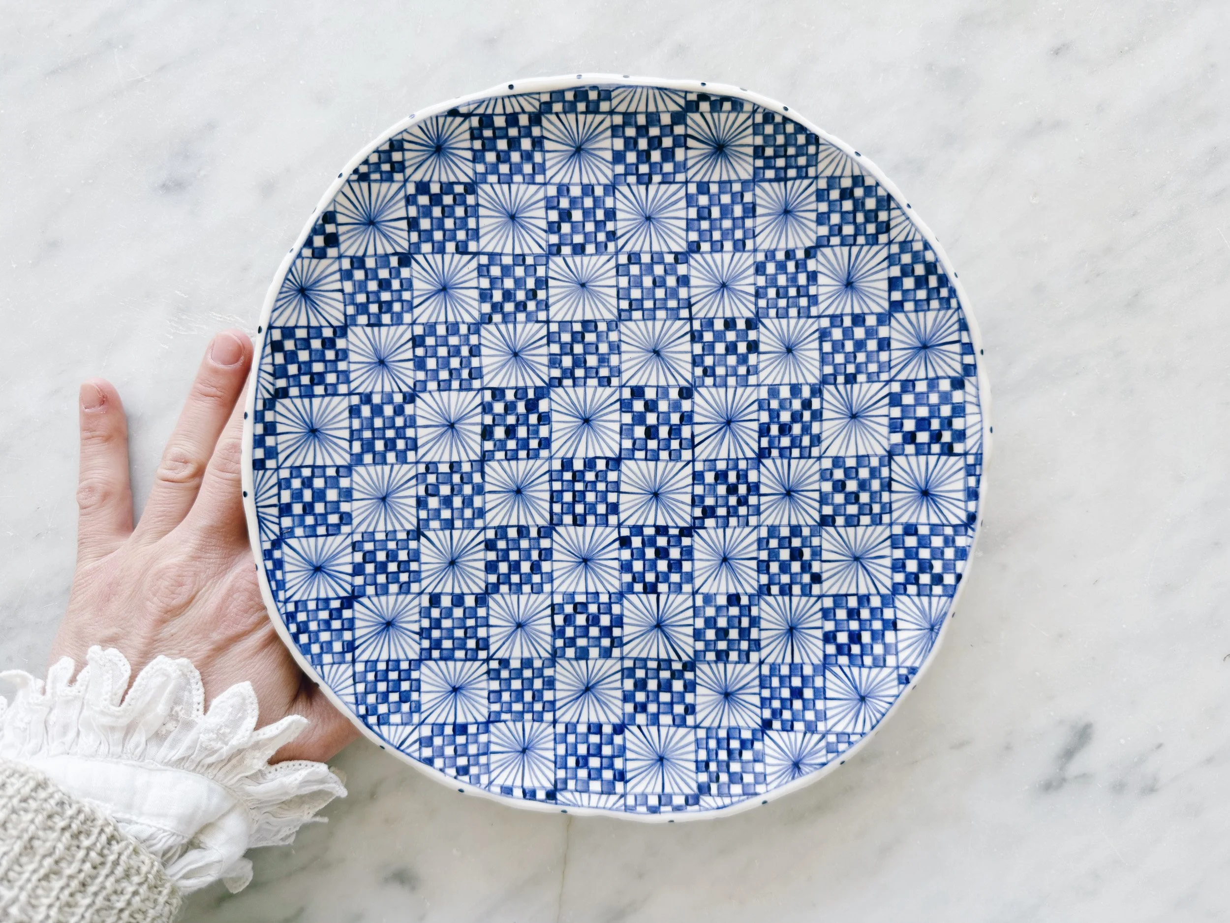 Blue and white, handmade ceramic raised plate.