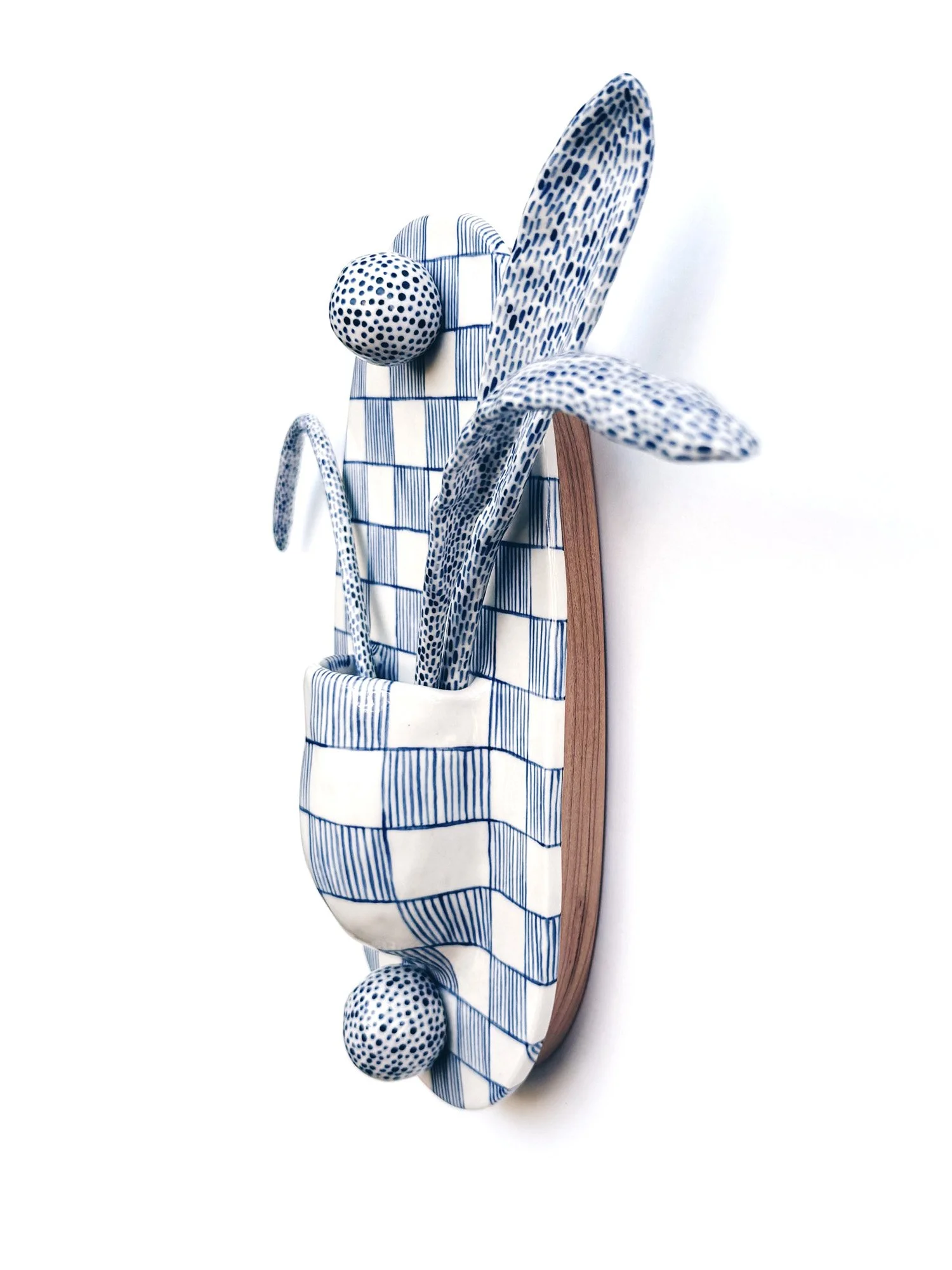 Blue and white, handmade ceramic wall hanging.