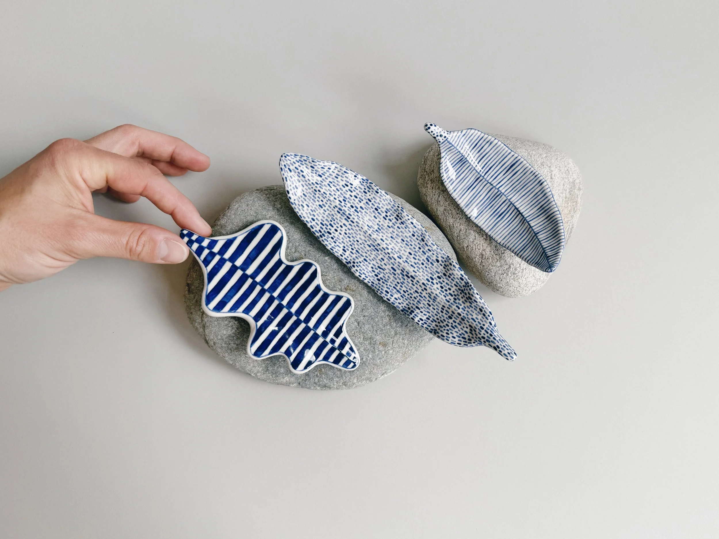 Blue and white, handmade ceramic leaf.