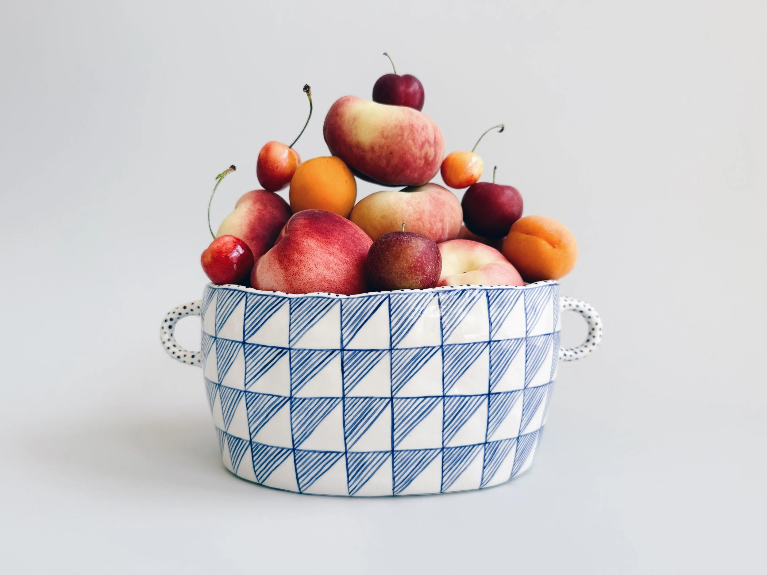 Blue and white, handmade ceramic vessel.