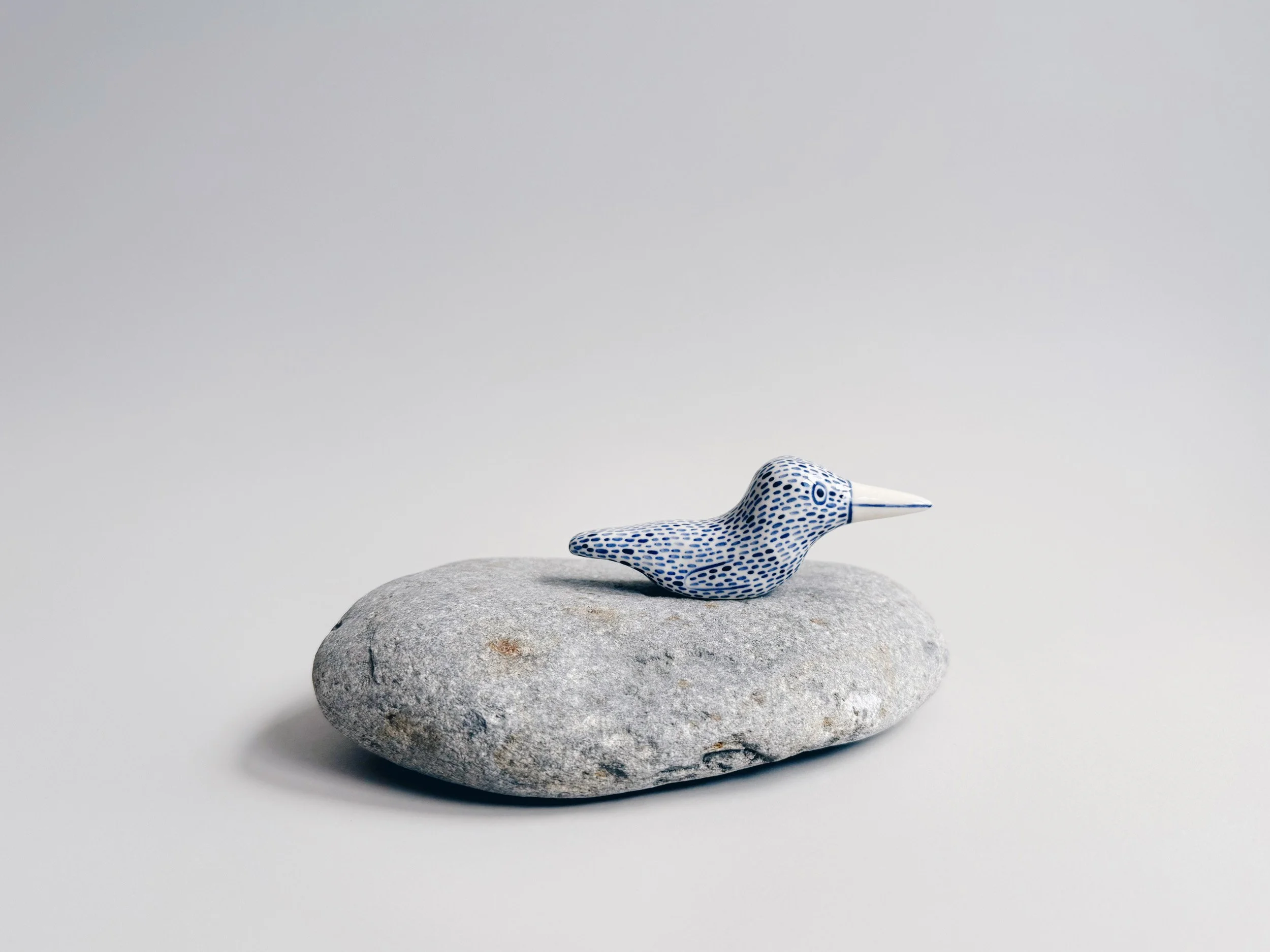 Blue and white, handmade ceramic bird.