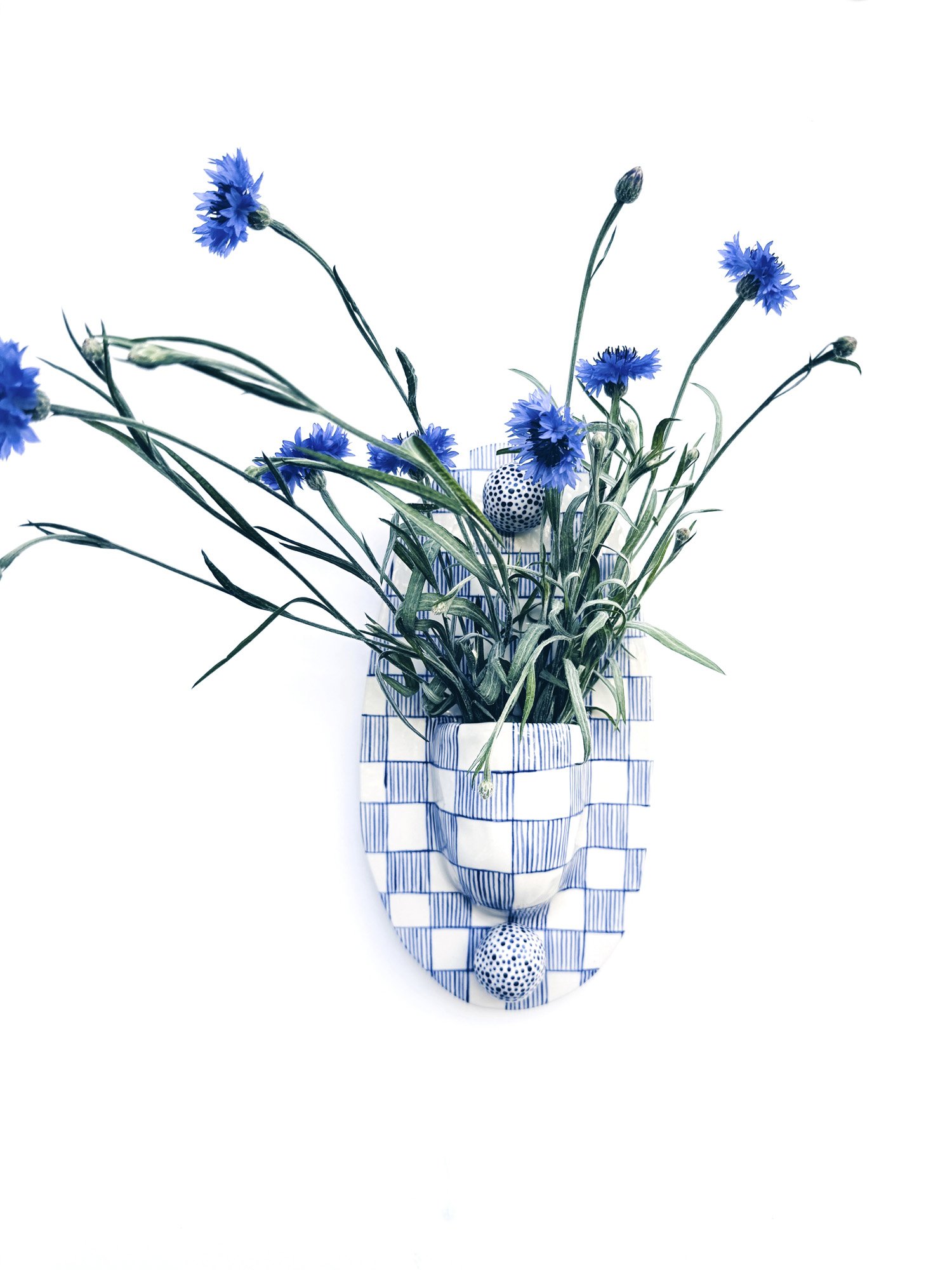 Blue and white, handmade ceramic wall hanging.