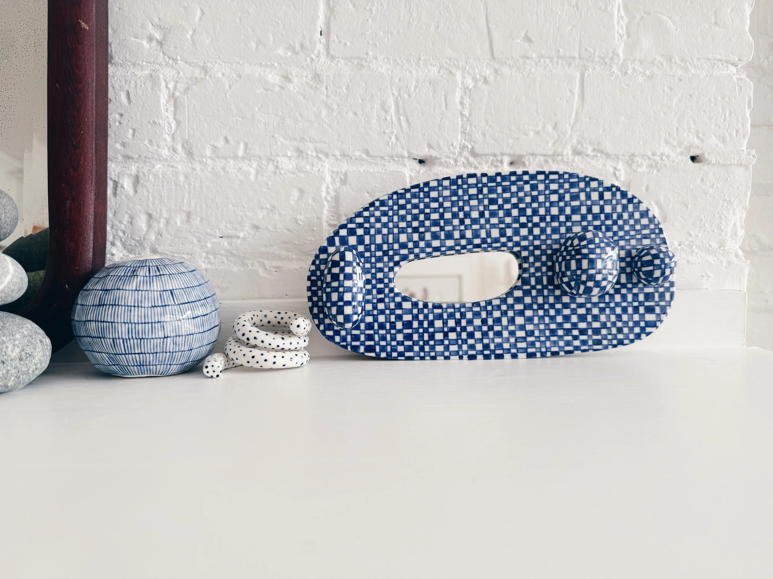 Blue and white, handmade ceramic mirror.