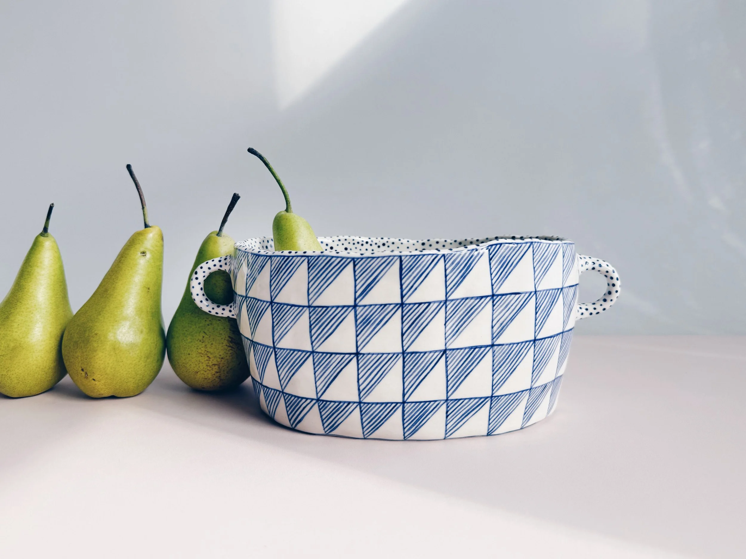 Blue and white, handmade ceramic vessel.