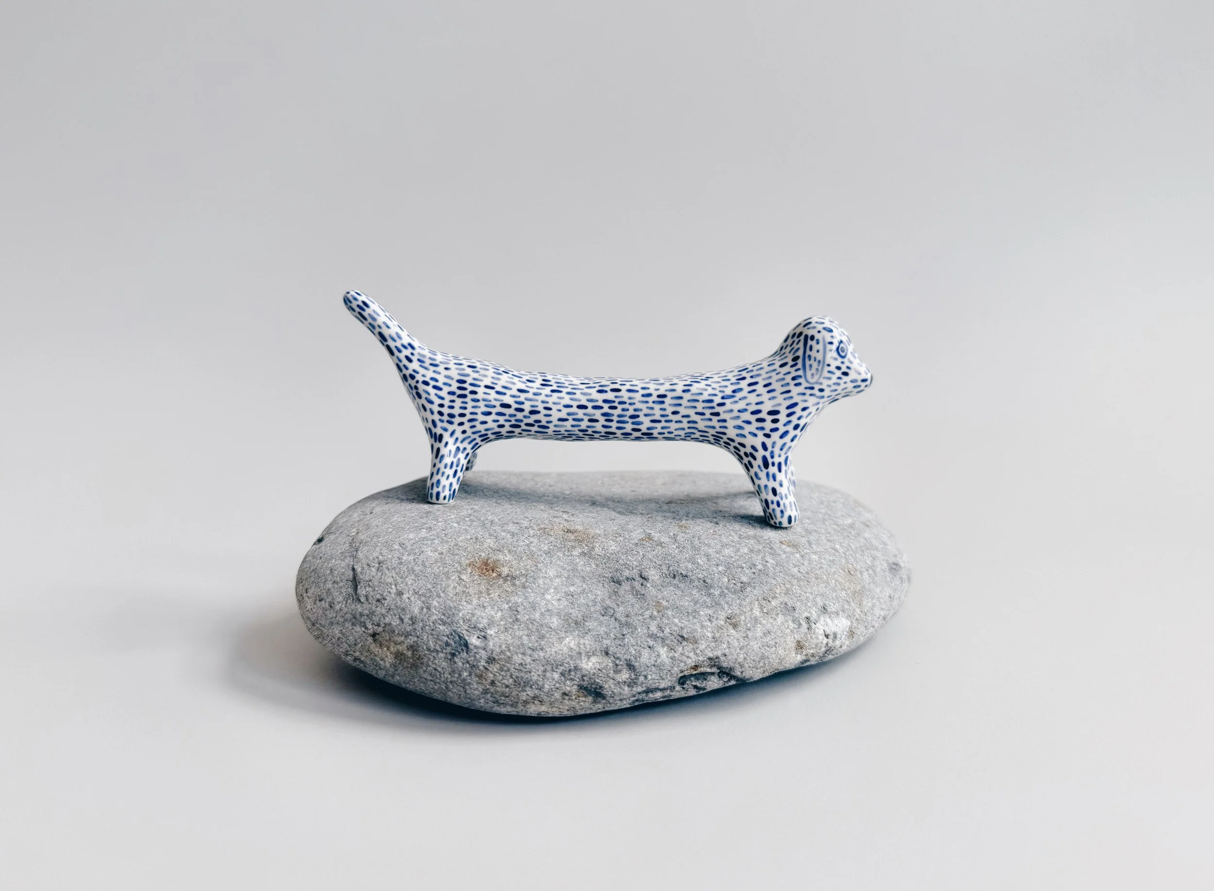 Blue and white, handmade ceramic dog.