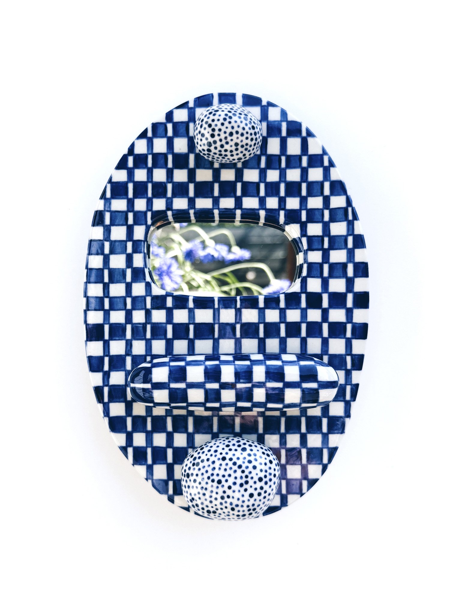 Blue and white, handmade ceramic mirror.