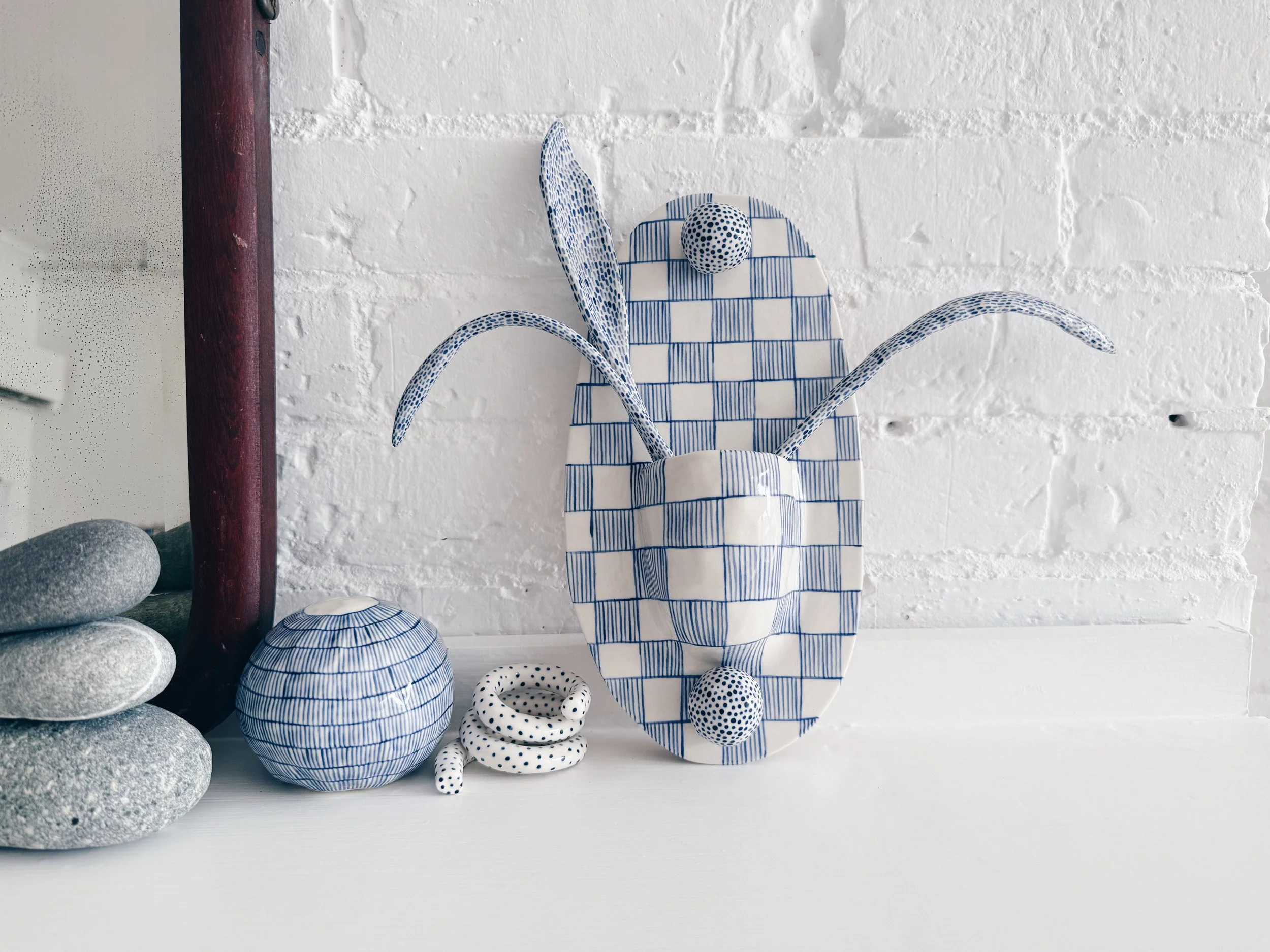 Blue and white, handmade ceramic wall hanging.