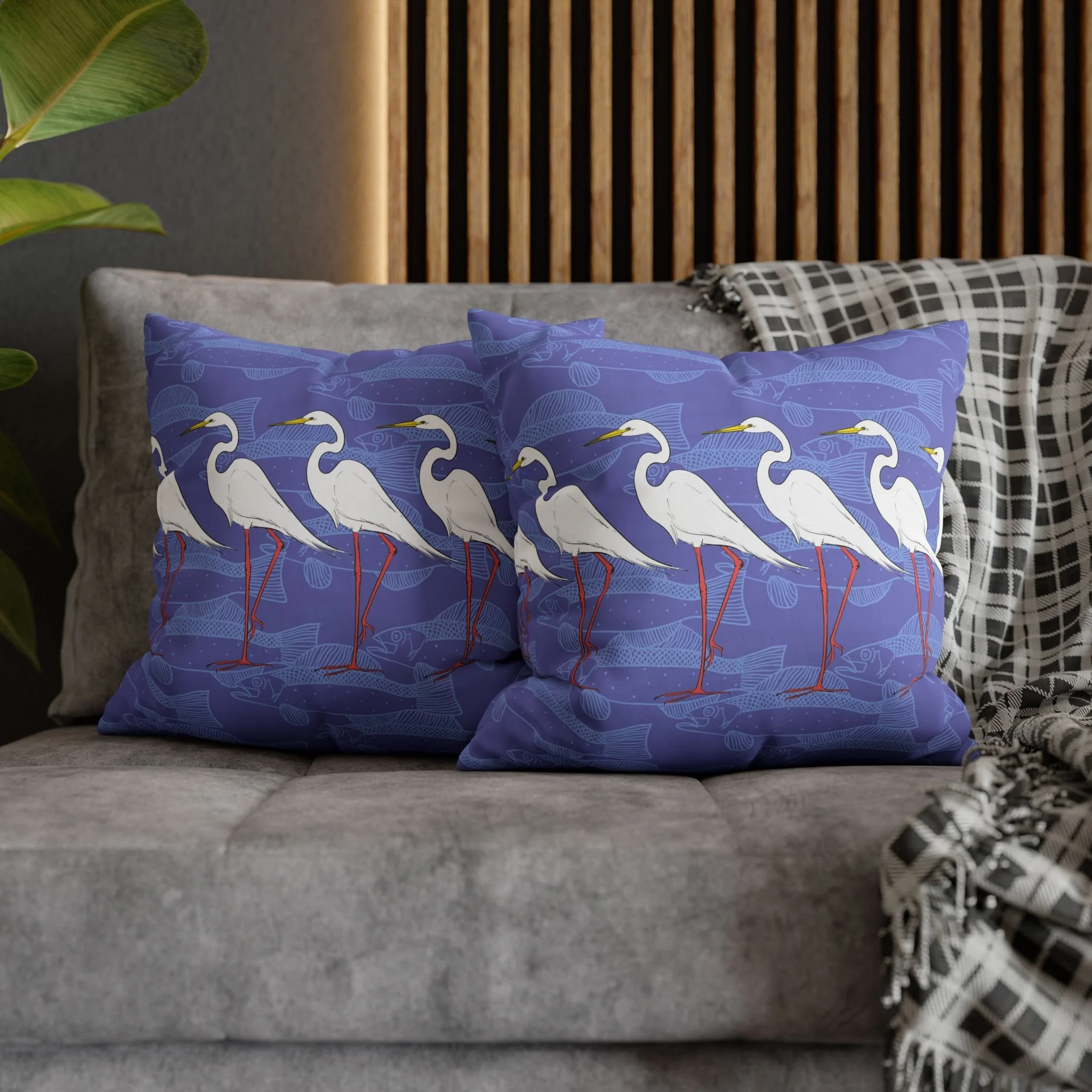 Egrets and Fish by Elisabeth Maurland - Matching Throw Pillows on Gray Couch.png